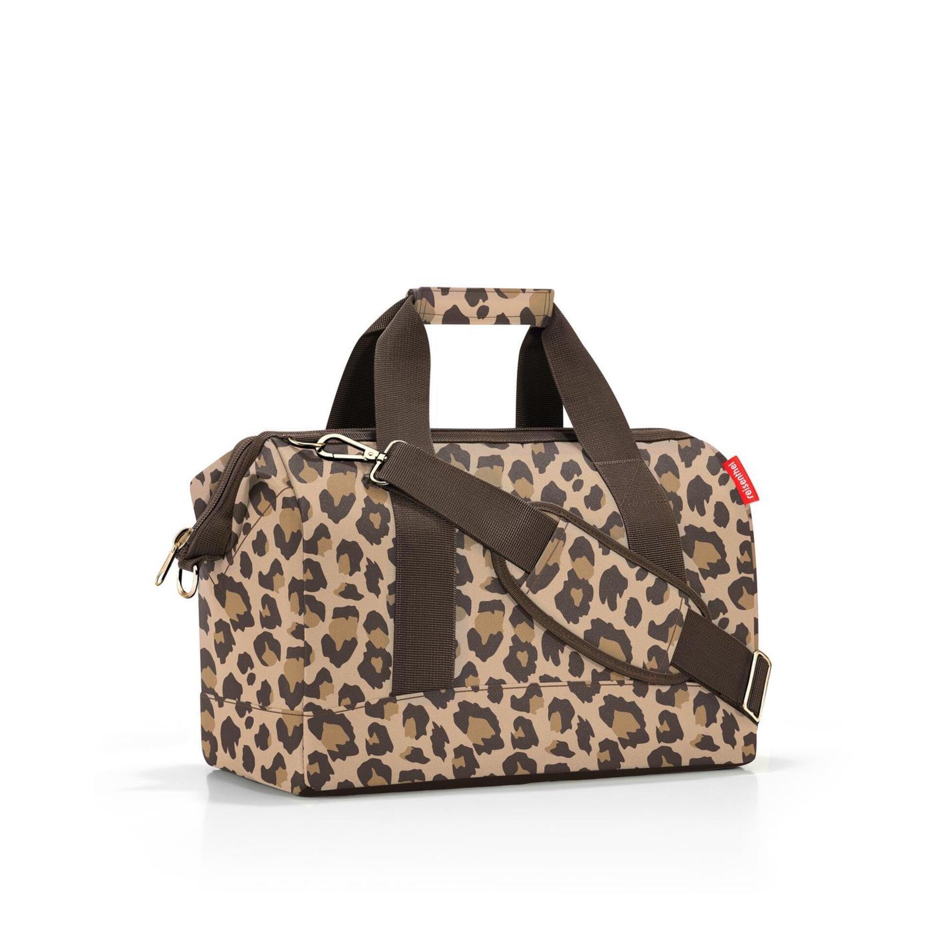 Reise-Tragetasche Allrounder m mit Leopardenmuster, zwei Henkeln, einem goldenen Metallbeschlag und abnehmbarem Schultergurt.