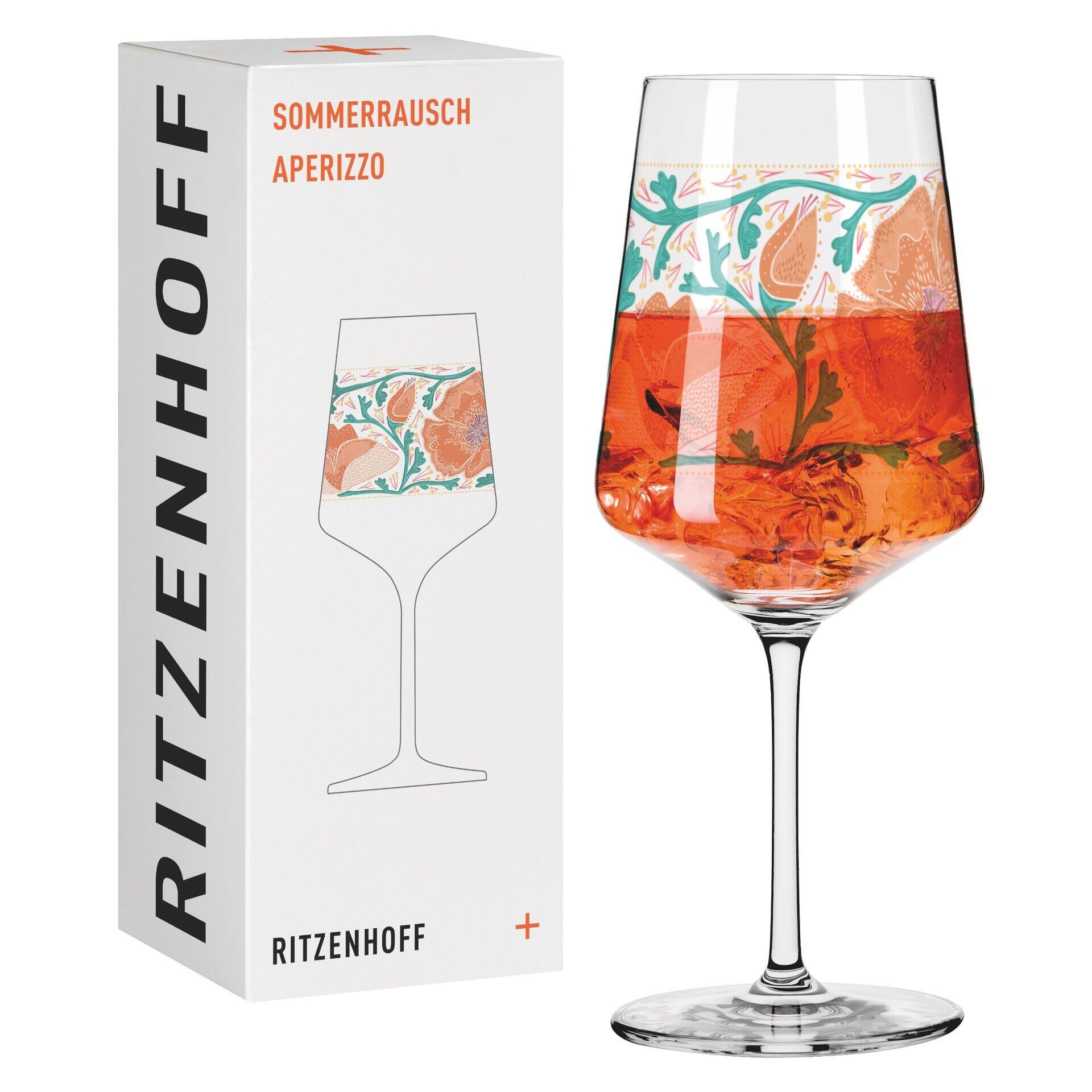 Aperitifglas mit sommerlichem Blüten- und Blättermotiv auf weißem Hintergrund, zusammen mit einer Geschenkbox mit "SOMMERRAUSCH" und "APERIZZO"-Aufdruck.