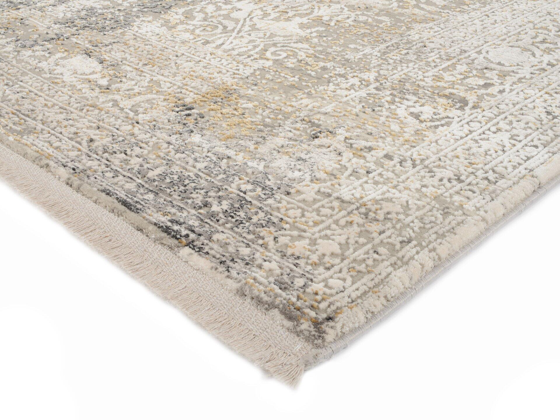 Maschinenwebteppich Amasya mit floralen und geometrischen Mustern in Weiß, Beige und Gelb, Detailaufnahme mit gerafftem Rand.