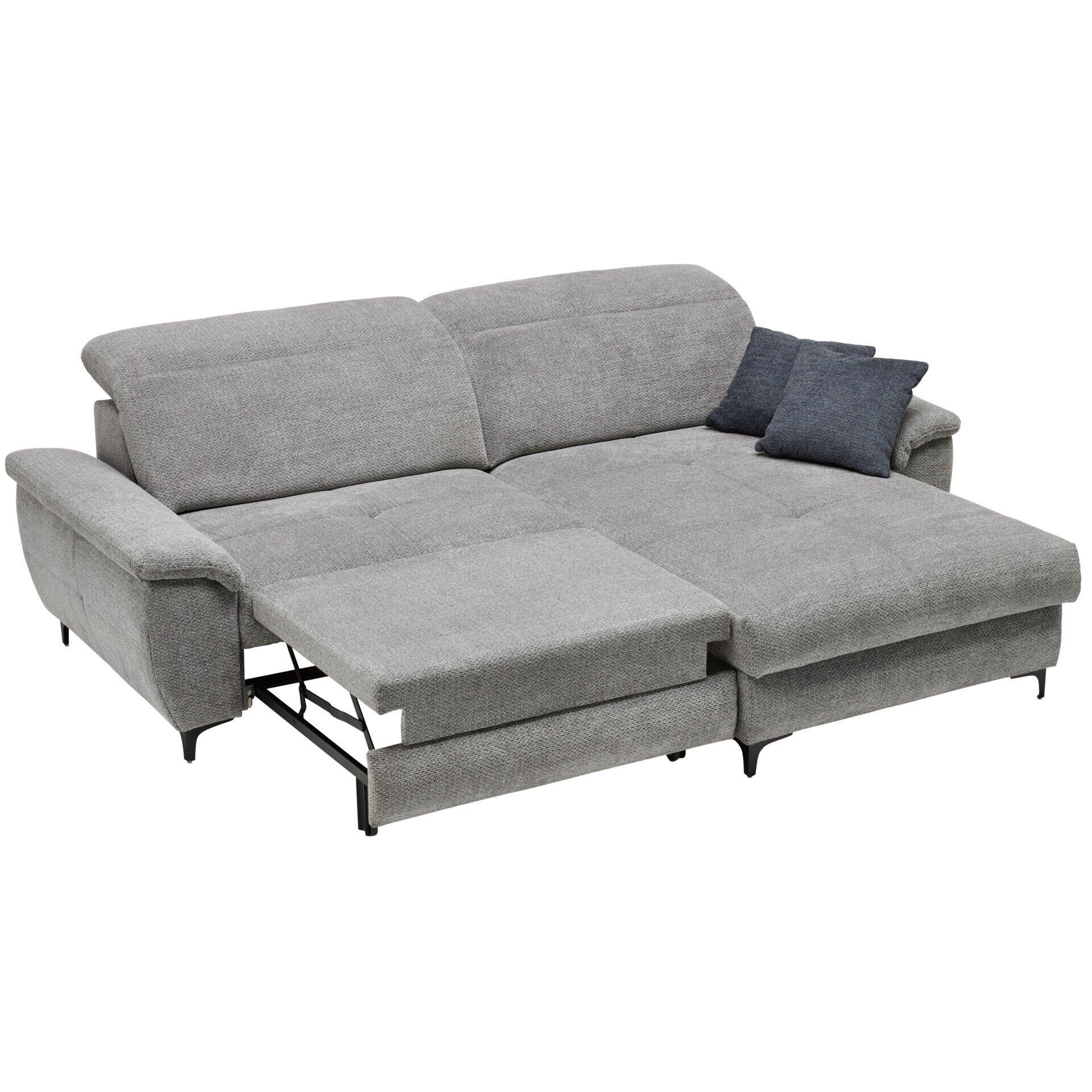 Ecksofa Retro mit abklappbarer Kopfstütze, Bettkasten und ausgezogener Schlaffläche auf schwarzen Metallfüßen, leicht schräg fotografiert, um die Gesamtform zu zeigen.