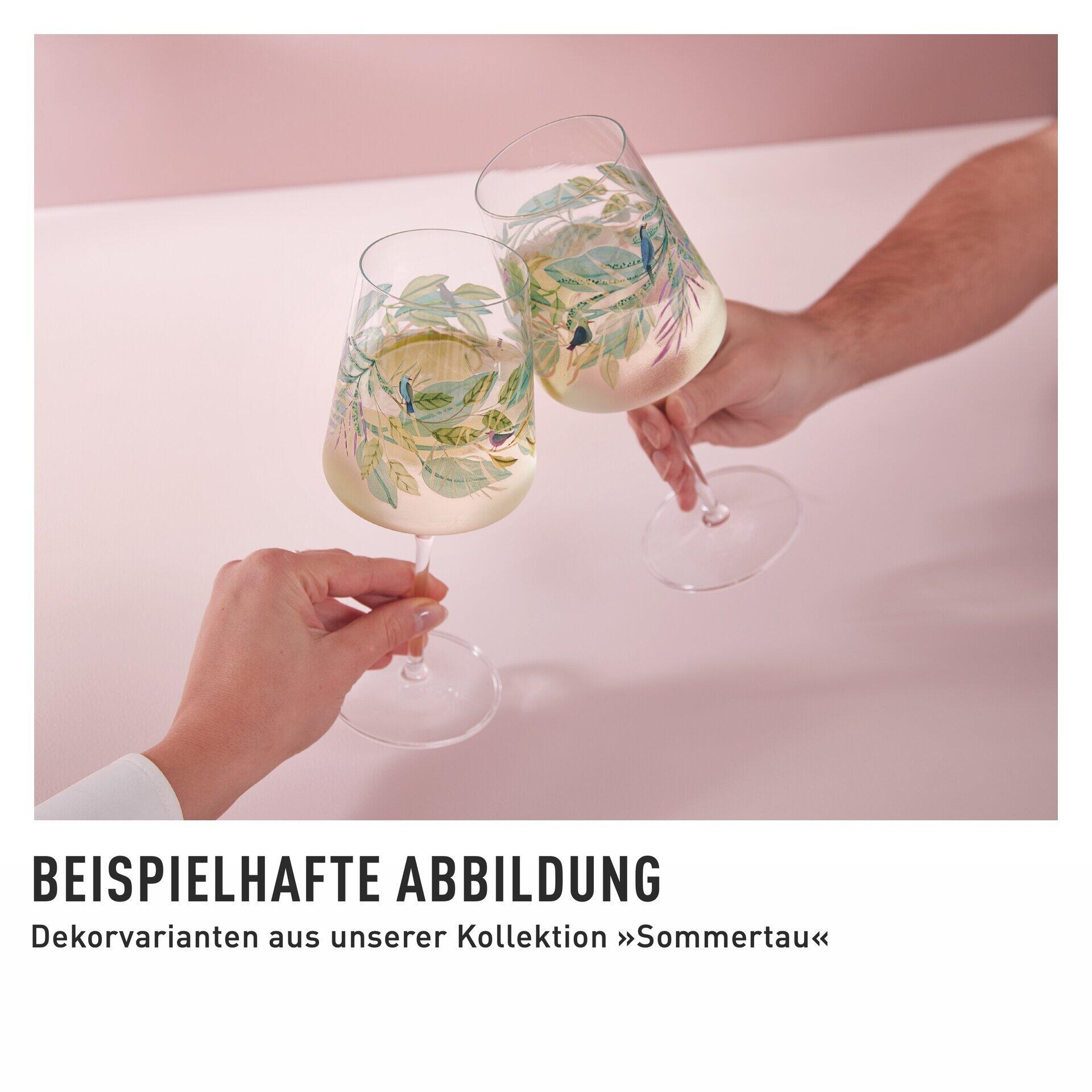 Nahaufnahme von zwei eleganten Aperitifgläsern mit floralem Dekor, gehalten in Händen und aus Vogelperspektive betrachtet.