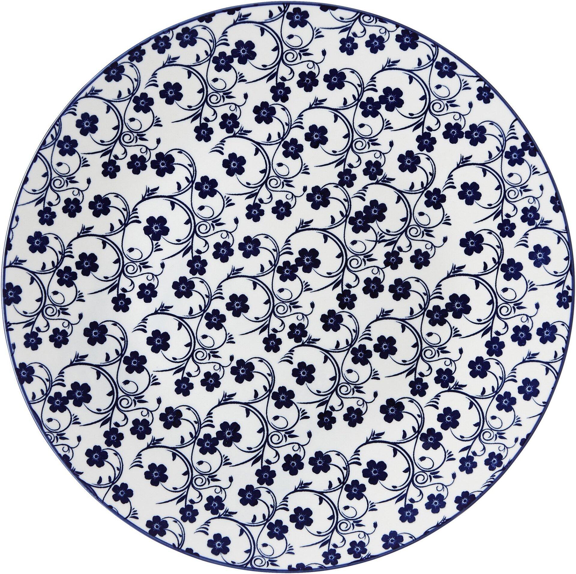 Teller Flach Sakura, Detailaufnahme eines runden Tellers mit blauem, floralem Dekor auf weißem Hintergrund.