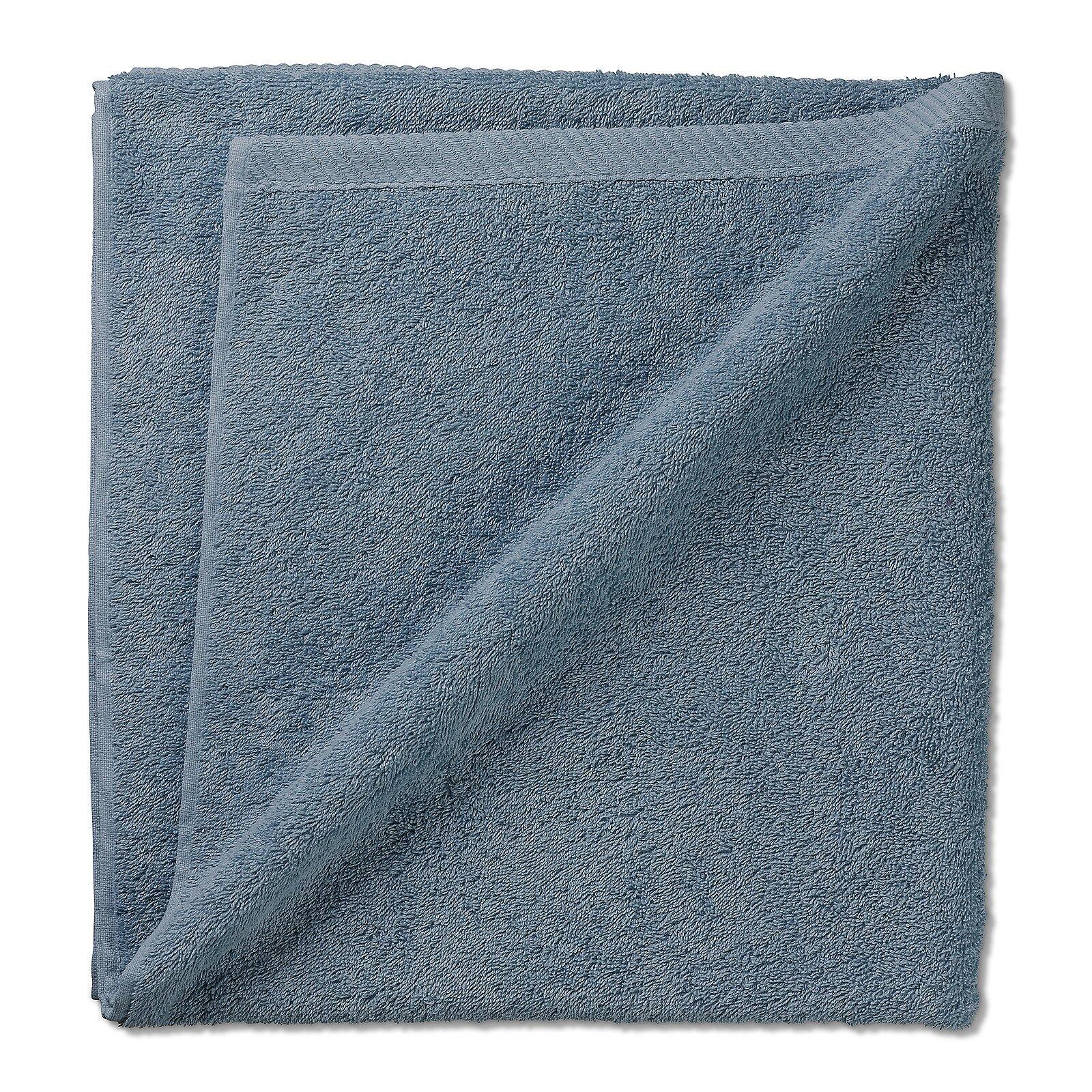 Hellblaues Duschtuch Ladessa, flauschig gefaltet auf weißem Untergrund, zeigt die Frottee-Struktur und die Abmessungen von 140x70cm.