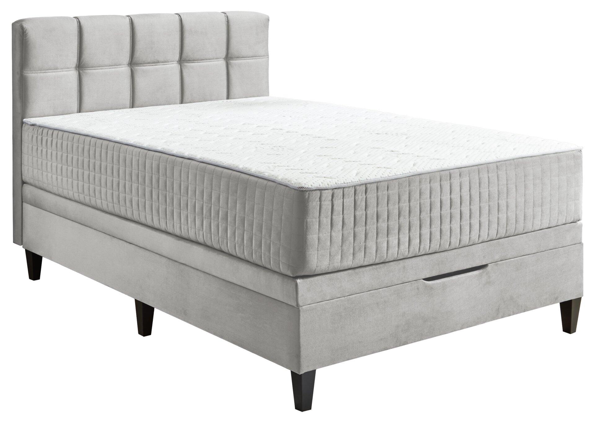 Boxspringbett Wien BX2590 mit hohem, gesteppten Kopfteil, integriertem Bettkasten und schrägen Füßen, aus leicht erhöhter Perspektive.