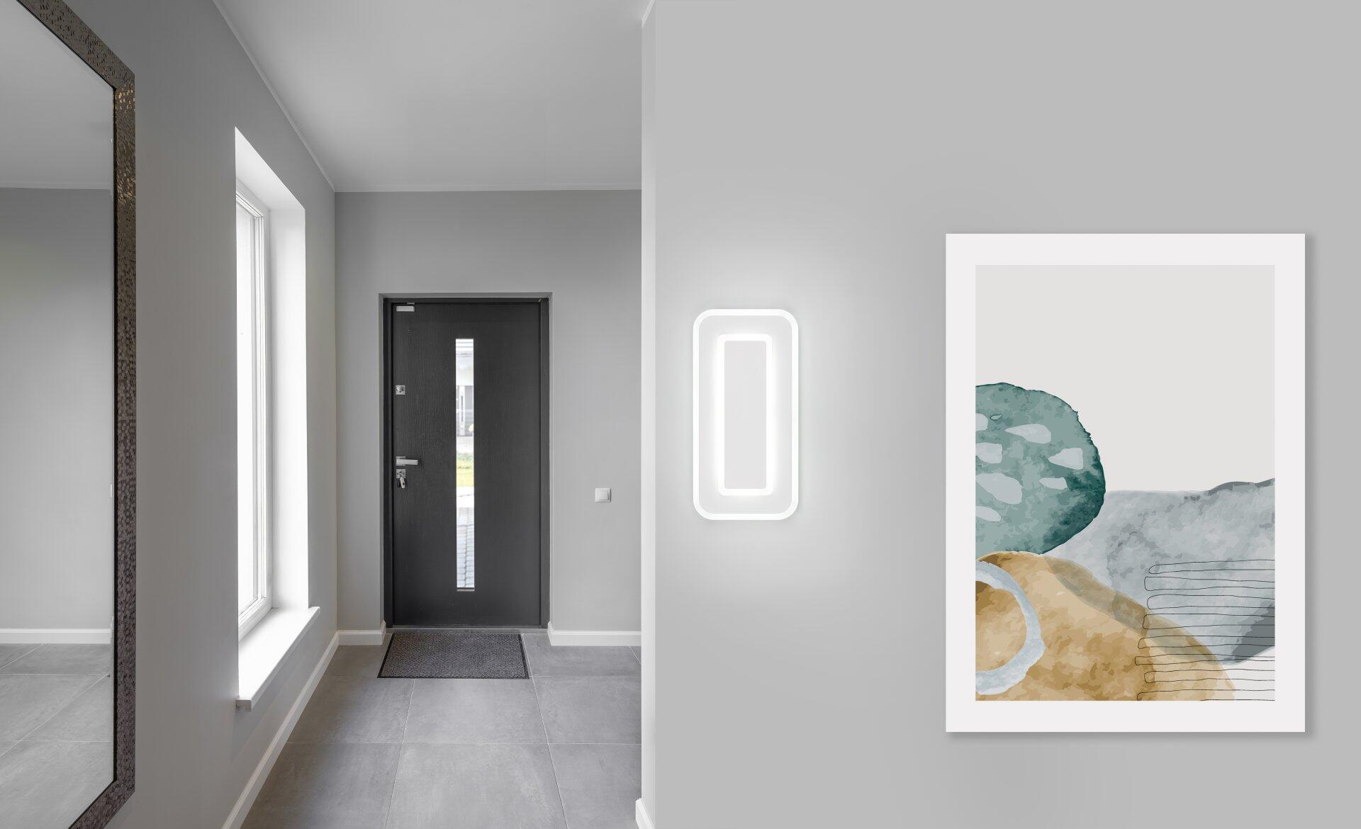 Deckenleuchte Riva als beleuchteter Wandrahmen in einem modernen Flur mit stufenlos einstellbarer Lichtfarbe und gleichmäßiger Ausleuchtung.