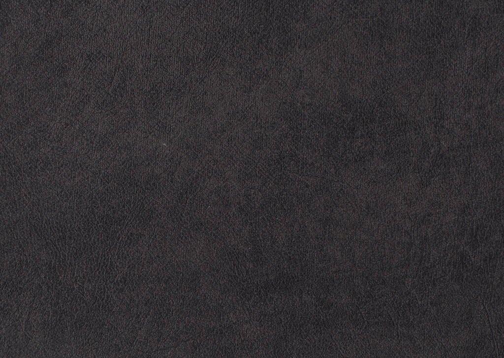 Nahaufnahme des strukturierten, dunkelblauen Stoffes des Ecksofas Balina, der eine weiche und samtige Textur mit feinen Unebenheiten zeigt.