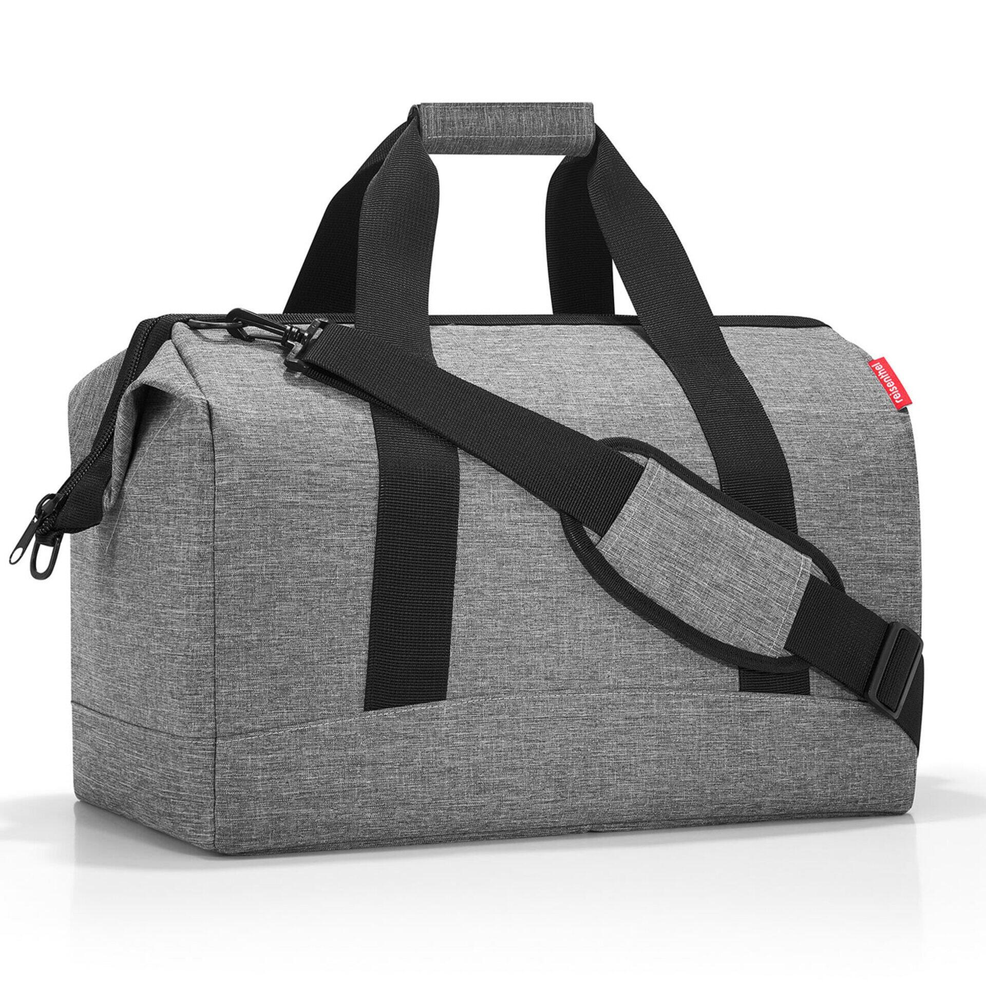 Graue Reisetasche Allrounder l mit zwei Tragegriffen, Schultergurt und zwei Reißverschlüssen, aus Seitenperspektive auf weißem Hintergrund.