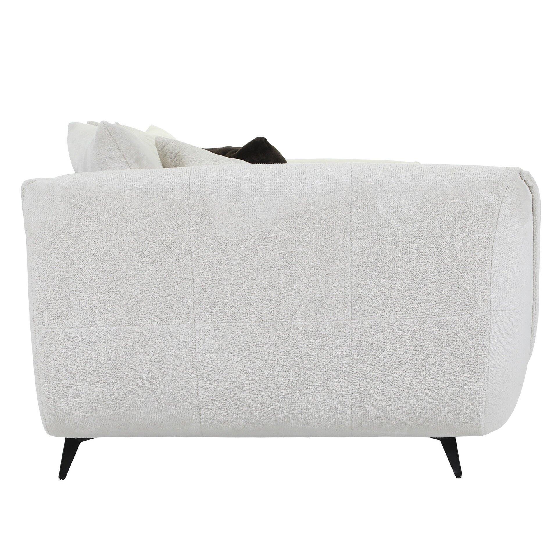 Seitenansicht eines grauen Sofas mit hoher, leicht abgerundeter Rückenlehne, schmalen, konischen Füßen und zwei Kissen auf der Lehne.