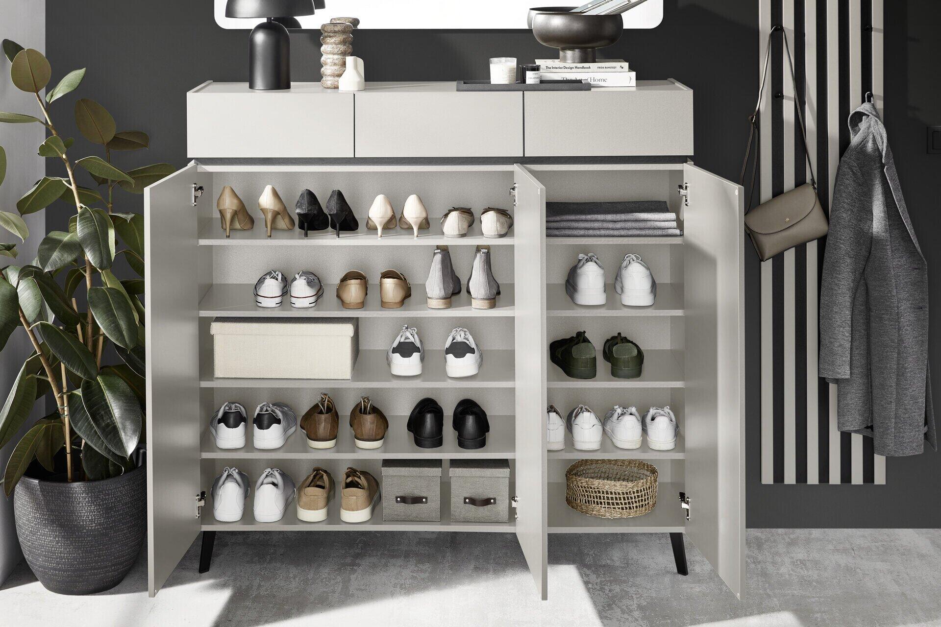Weißer Schuhschrank Unique mit drei Türen, drei Schubladen und mehreren Einlegeböden für eine übersichtliche Schuhaufbewahrung, abgebildet aus frontaler Perspektive in einer modernen Diele.