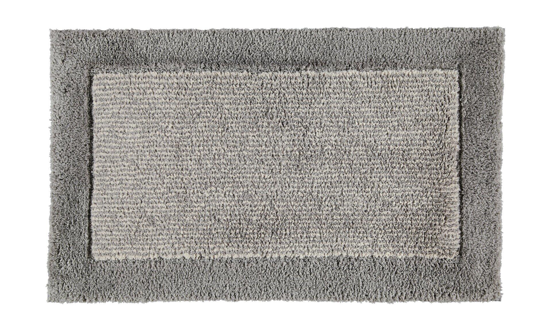 Waschhandschuh Two-Tone auf grauem Teppich aus Vogelperspektive.