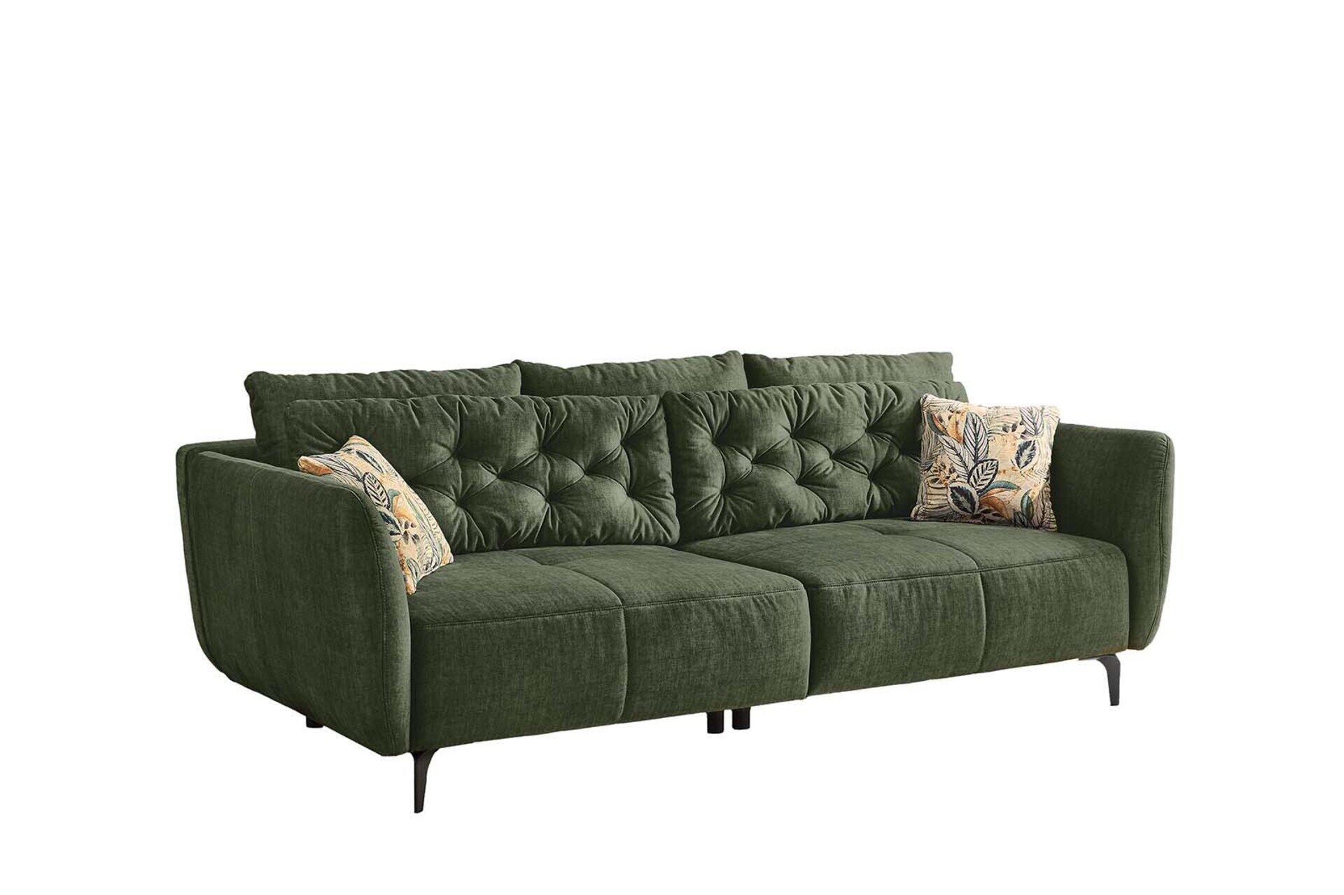 Big Sofa Spa Eckcouch in Grün mit strukturierter Steppung, breiten abgerundeten Armlehnen und dekorativen Kissen in Beige- und Grüntönen, aus 3/4-Perspektive.