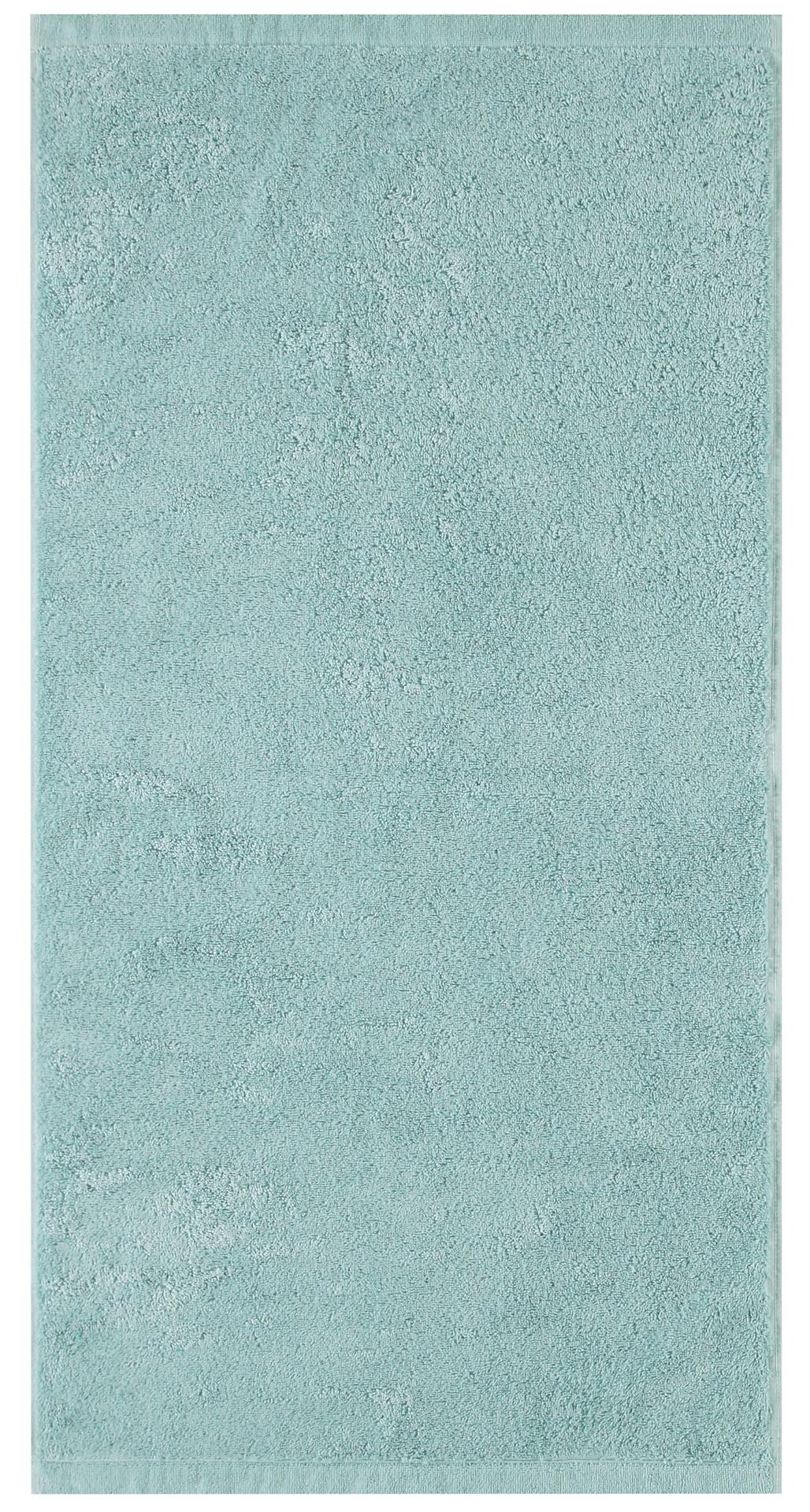 Seegrüner CAWÖ Handtuch auf einem hellblau-grünen Teppich, der flauschige Textur und eine hohe Dichte zeigt.