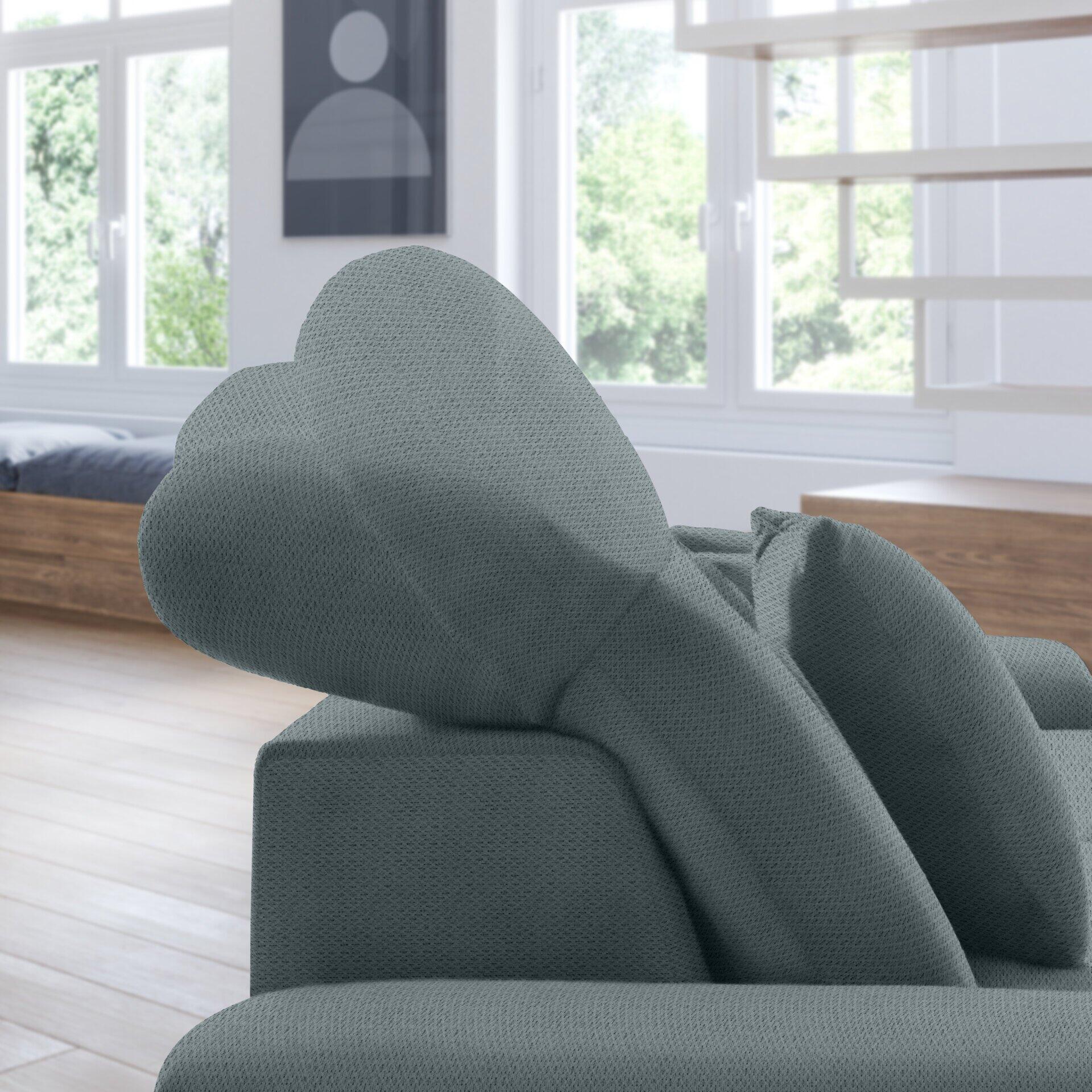 Nahaufnahme eines grauen Retro-Ecksofas mit strukturierter Oberfläche und abklappbarer Kopfstütze, das die gepolsterte Rückenlehne und Armlehnen betont.