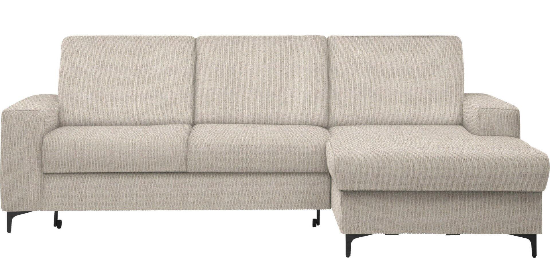 Beiges Ecksofa Balina mit schwarzem Metallfuß und abklappbarer Schlaffläche, dargestellt in Frontalperspektive mit leicht gewellter Rückenlehne aus Kissen.