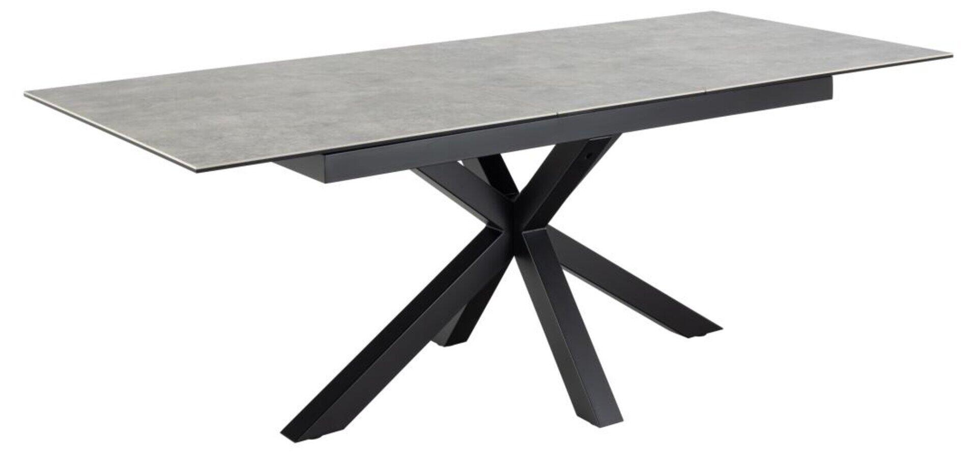 Esstisch Heaven in ¾-Ansicht mit ausgeklappter Verlängerung und fächerförmigem schwarzem Metalluntergestell.