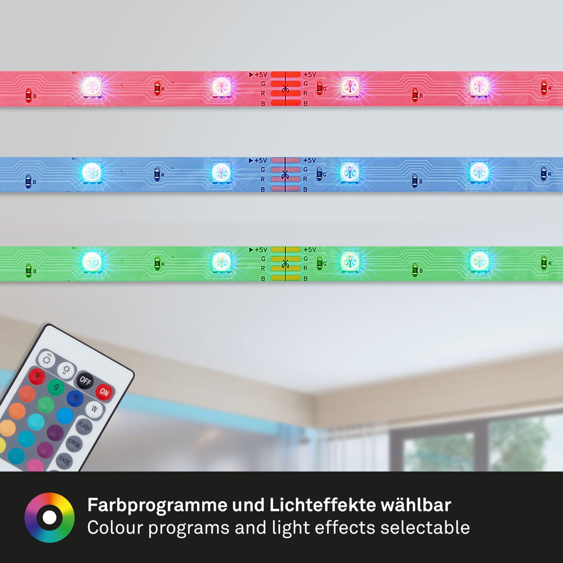 LED Band Led Superline mit Farbverlauf von Rot bis Violett und programmierbaren Lichteffekten hinter einem weißen Möbelstück.