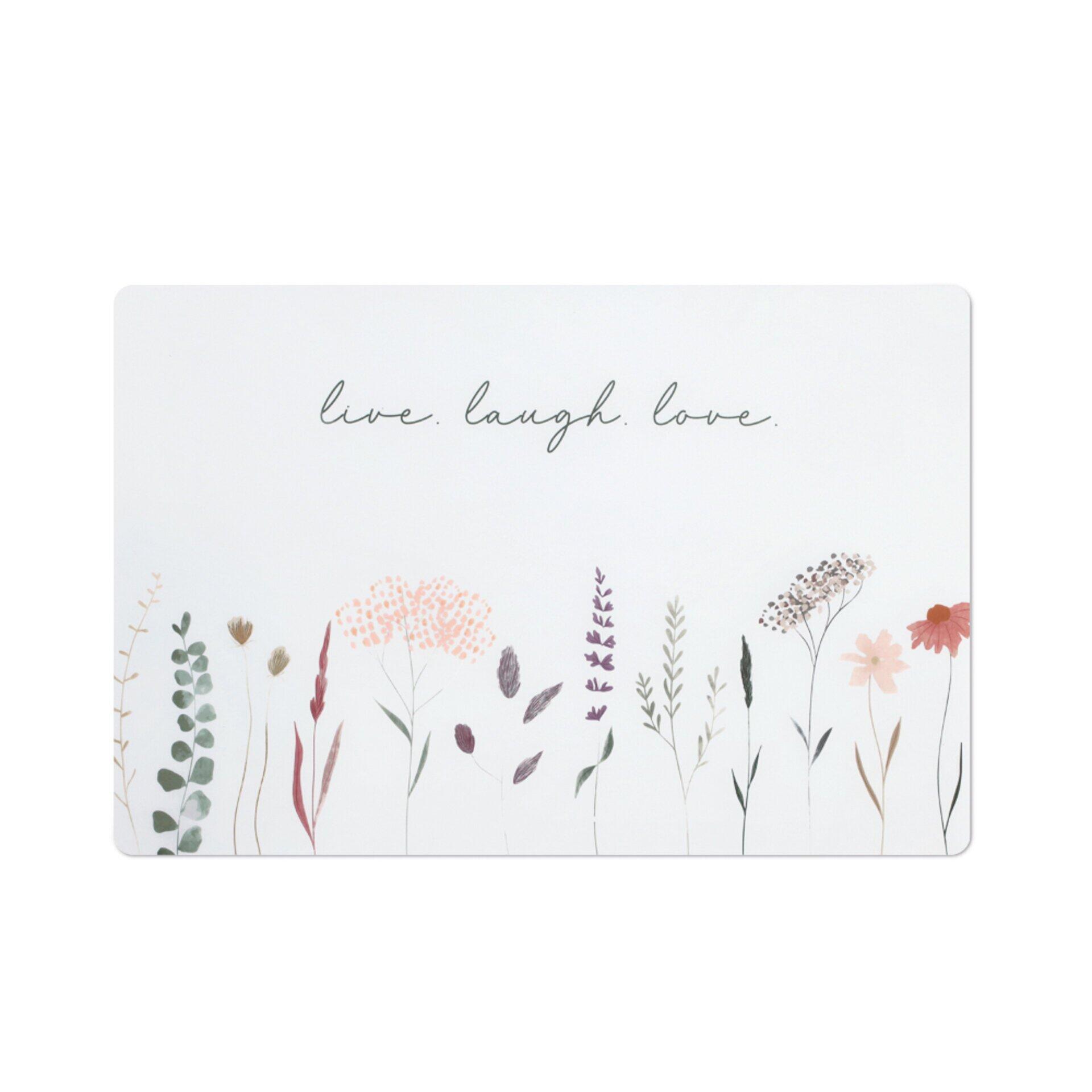 Rechteckiges Platzset mit floralem Design, weißem Hintergrund und perspektivischer Darstellung von Pflanzen und dem Schriftzug "live. laugh. love.".