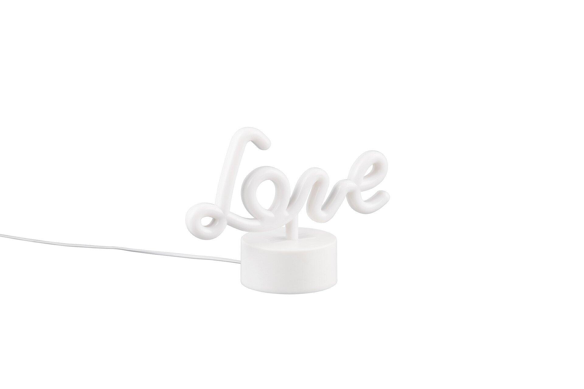 Tischleuchte Amor in Form des Wortes "Love" mit weißem Fuß und Kabel, aufgenommen aus schräger Perspektive.
