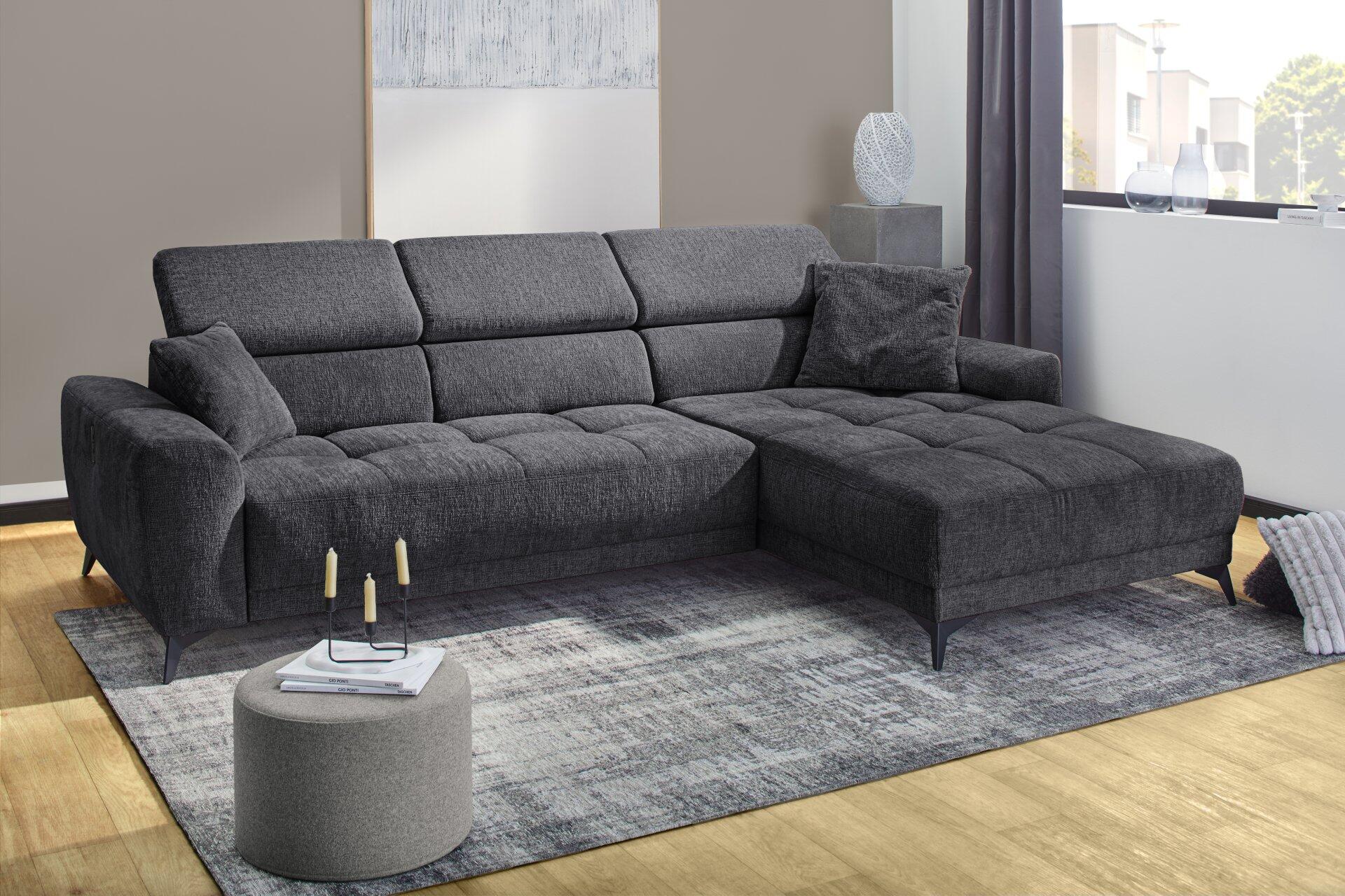Wohnlandschaft Drifter: Graue Eckcouch mit Chenille-Polsterung, Motorfunktion in den einzelnen Segmenten und filigranen schwarzen Metallfüßen, aus leicht erhöhter Frontalansicht.