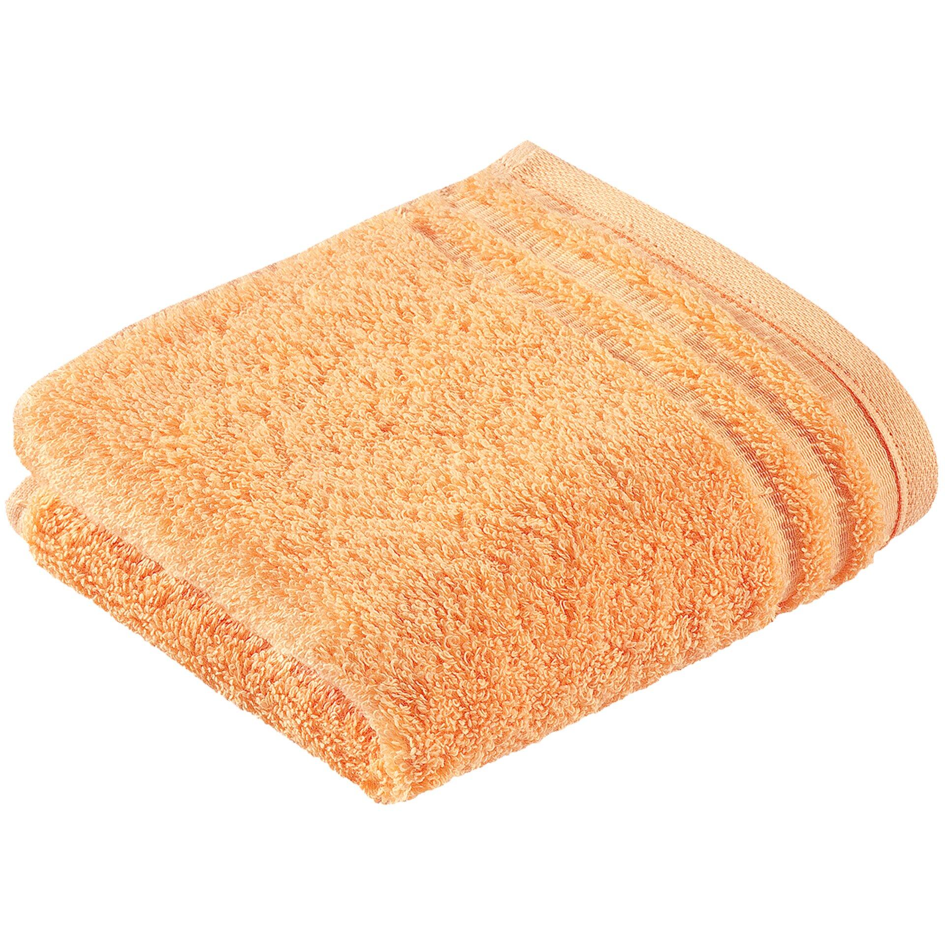 Gefaltetes Gästetuch ViennaStyleSupersoft in Apricot mit sichtbarer Textur und geriffelter Struktur auf weißer Unterlage.