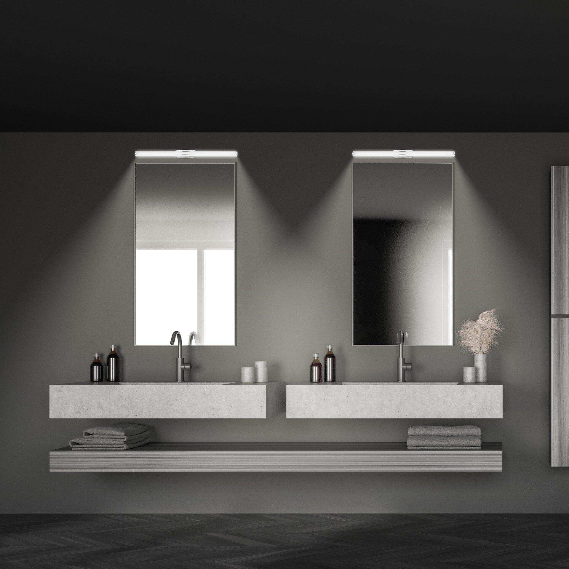 Wandmontierte Badezimmerleuchte Runt, schlankes Design mit LED-Technologie, beleuchtet einen modernen Doppelwaschtisch aus hellem Beton.