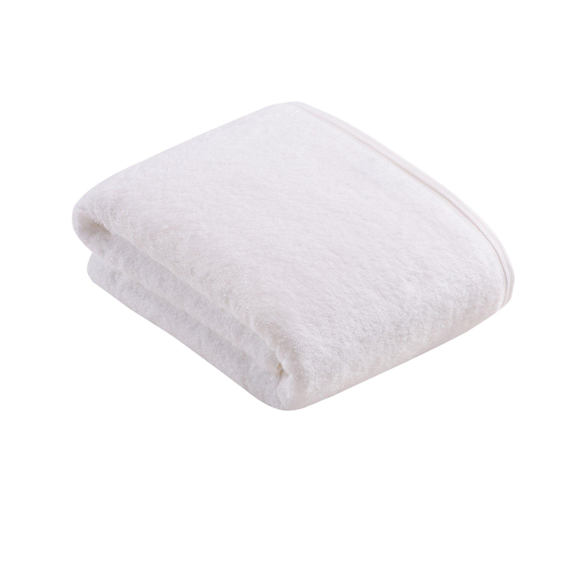 Flauschiges weißes Badetuch aus 100% SUPERSOFT Baumwolle, diagonal zur Betrachterperspektive gefaltet, um die Textur hervorzuheben.