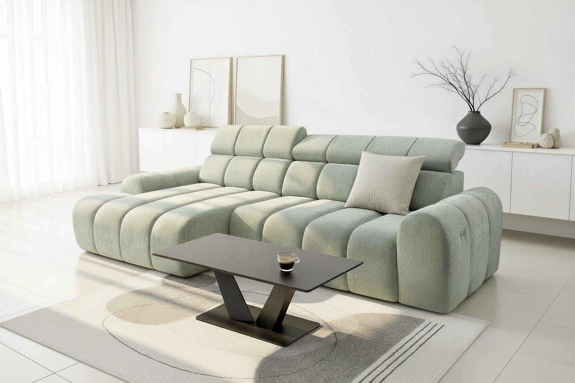 Hellgrünes Ecksofa Corfu mit modularer Formgebung und tiefen Sitzbereichen, aus leicht erhöhter Frontalperspektive fotografiert.