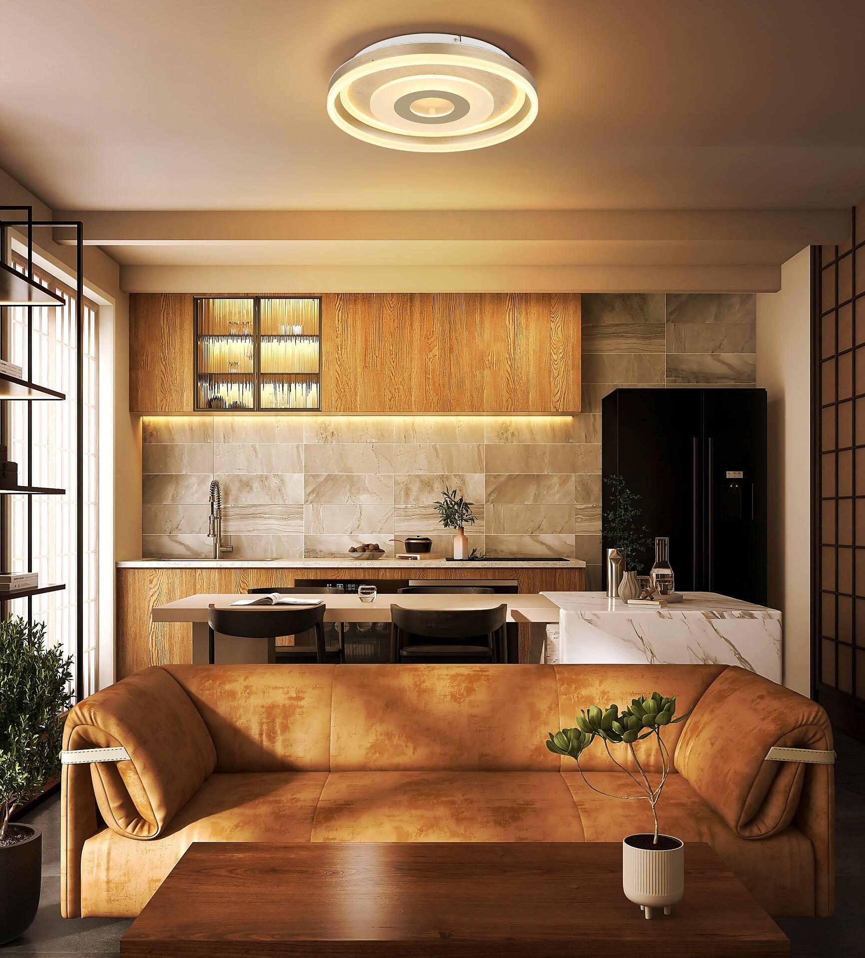 Moderne Deckenleuchte CARDENAS mit kreisförmiger Form, eingebunden in eine helle Wohnküche mit Ledersofa und Holzschränken.