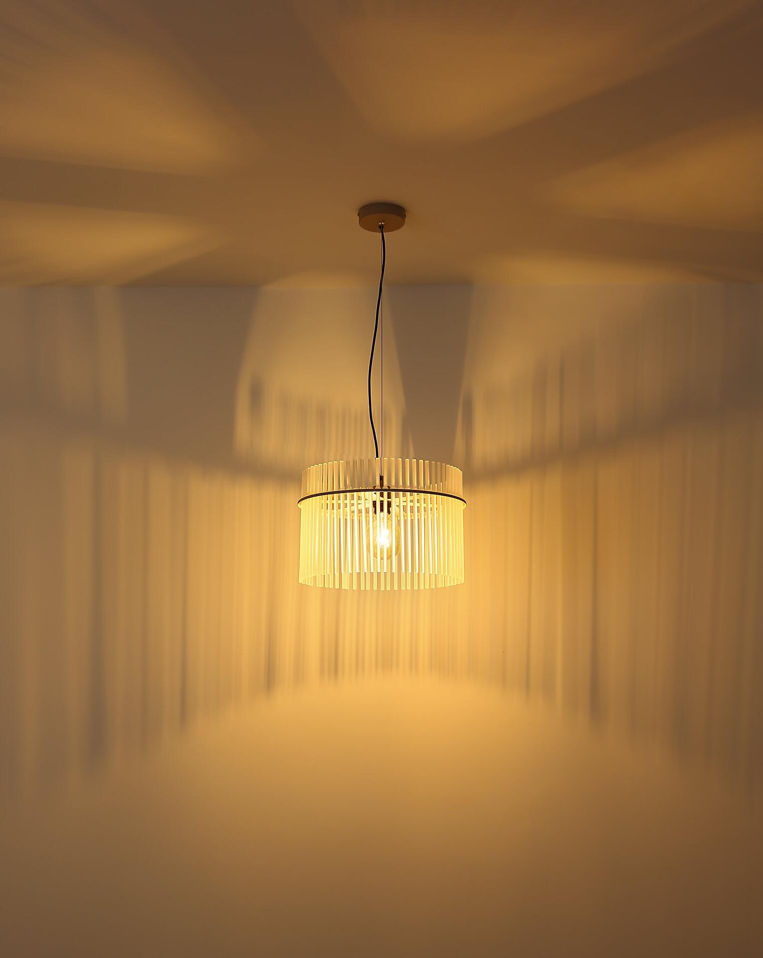 Hängeleuchte GORLEY mit zylindrischem, gelb-beigefarbenem Schirm und sichtbarer Glühbirne, die durch ein feines Kabel an der Decke aufgehängt ist.
