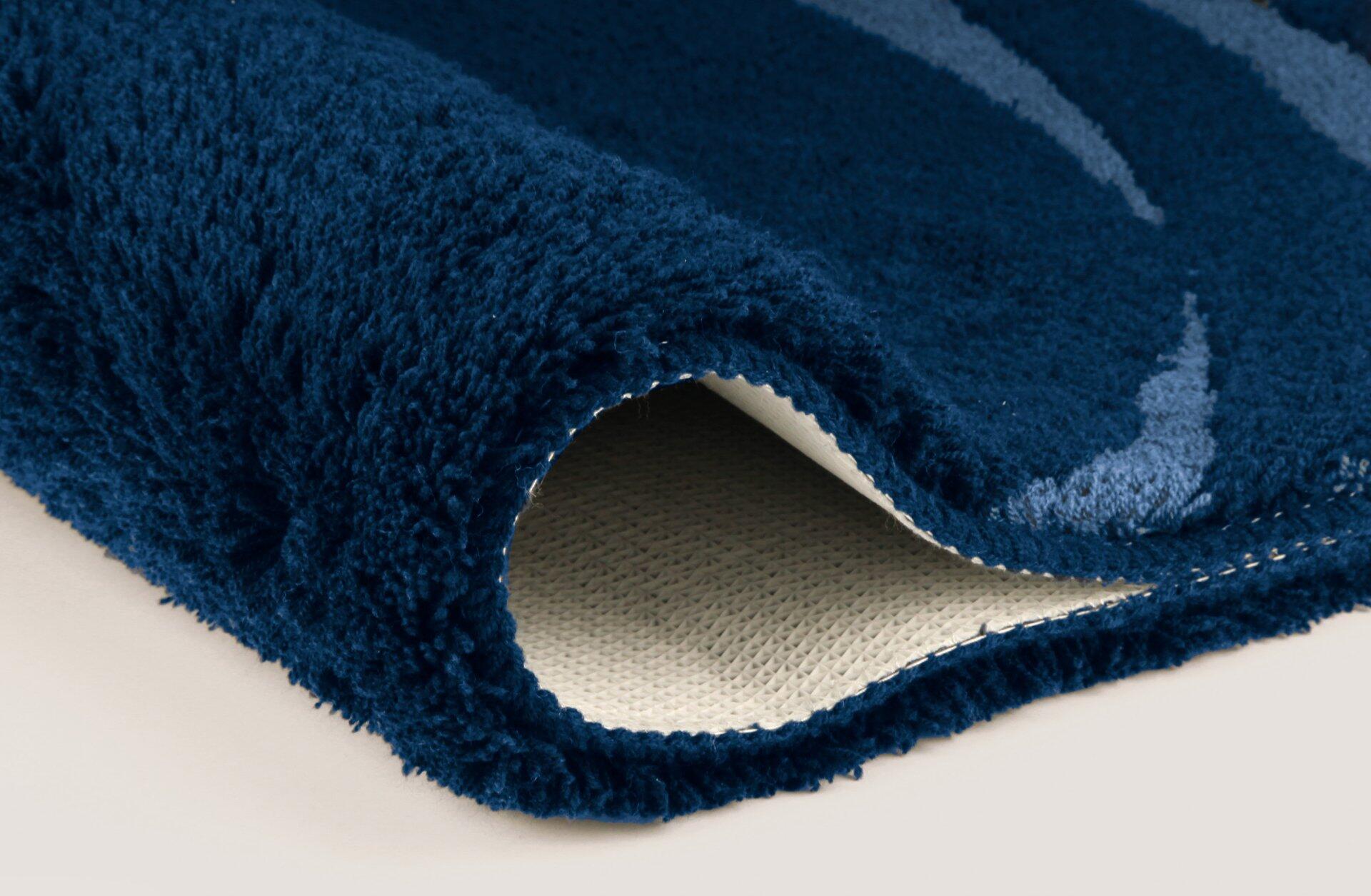 Dunkelblauer Badteppich Mystic mit weichem Flor und rutschfester Unterseite, detailreich aus Perspektive von oben dargestellt.