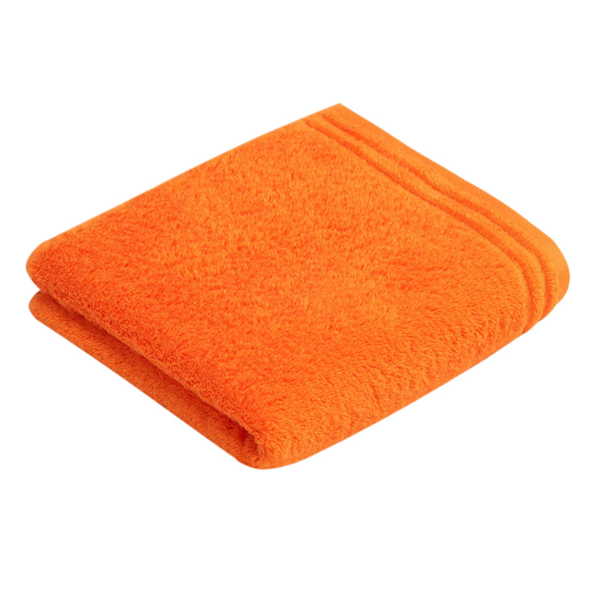 Orangefarbenes Handtuch Calypso Feeling aus flauschiger Baumwolle, gefaltet mit erhöhter Kante, auf weißem Untergrund.