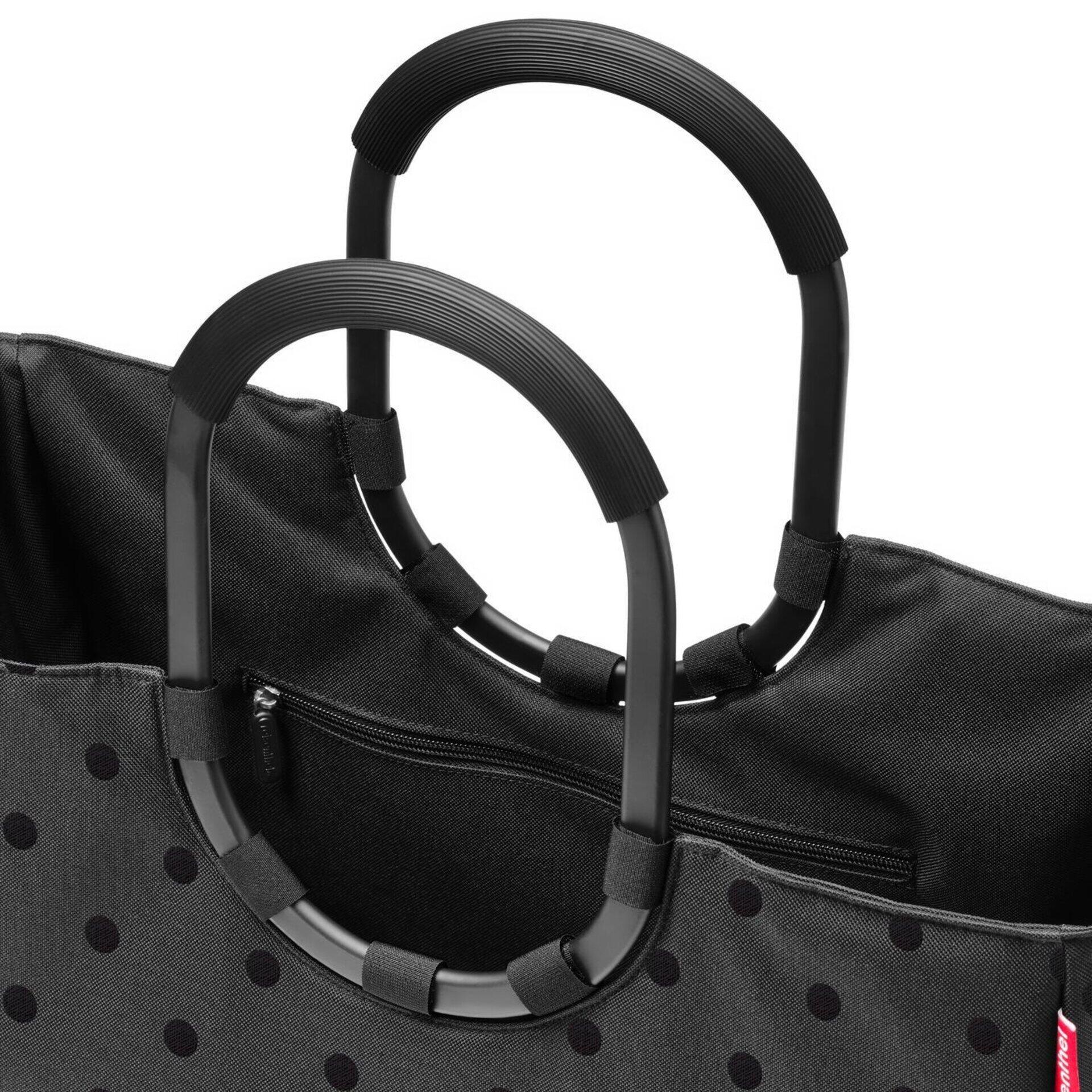Loopshopper l Tragetasche mit schwarzen Metallhenkeln im Ringdesign und Reißverschlussöffnung, die das geräumige Innere zeigt.