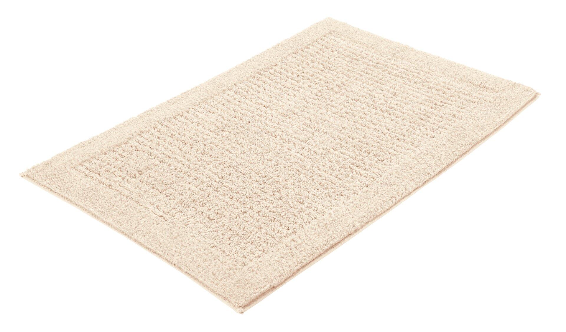 Badteppich Net: Rechteckige, hellbeige Fußmatte aus Baumwolle mit strukturierter Oberfläche aus feinen Vertikallinien.