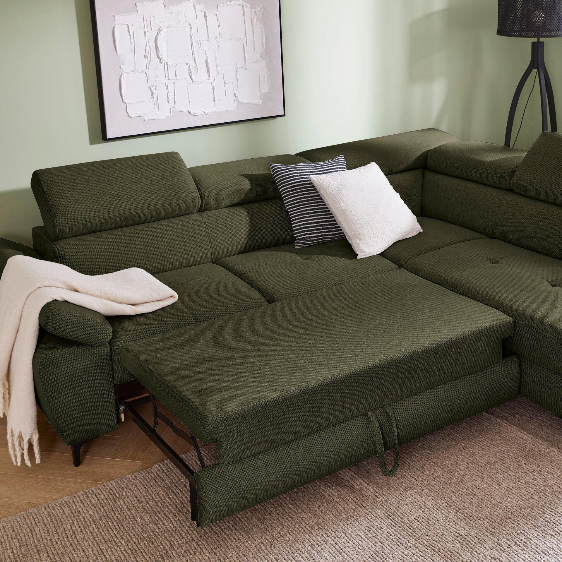 Grünes Ecksofa Combo mit ausgezogener Liegefläche und abklappbarer Kopfstütze in Innenraumansicht.