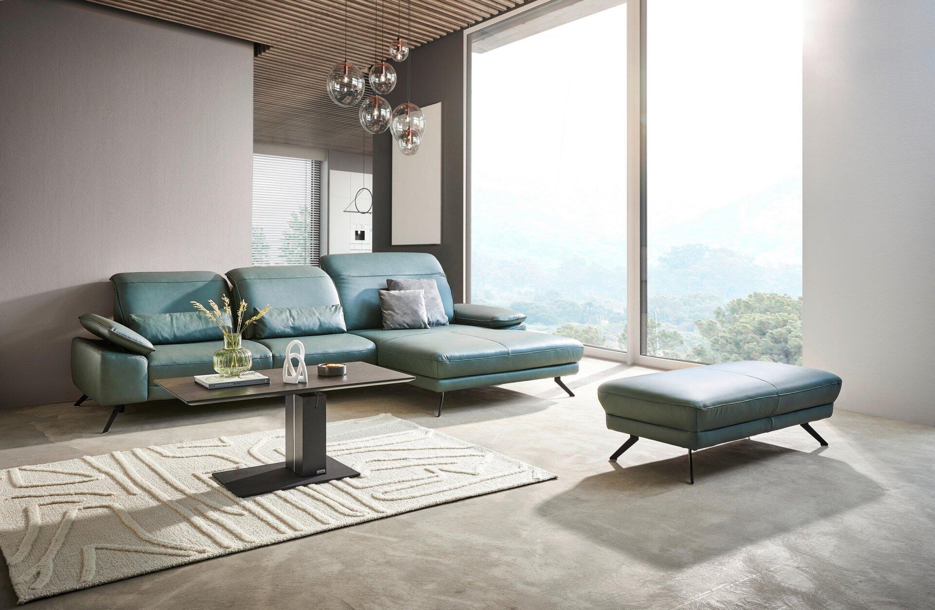 Couchtisch Milano mit rechteckiger Tischplatte und eckigem, eisenbeschichtetem Gestell, präsentiert vor einer modernen L-förmigen Couch und dekorativer Tischgestaltung.