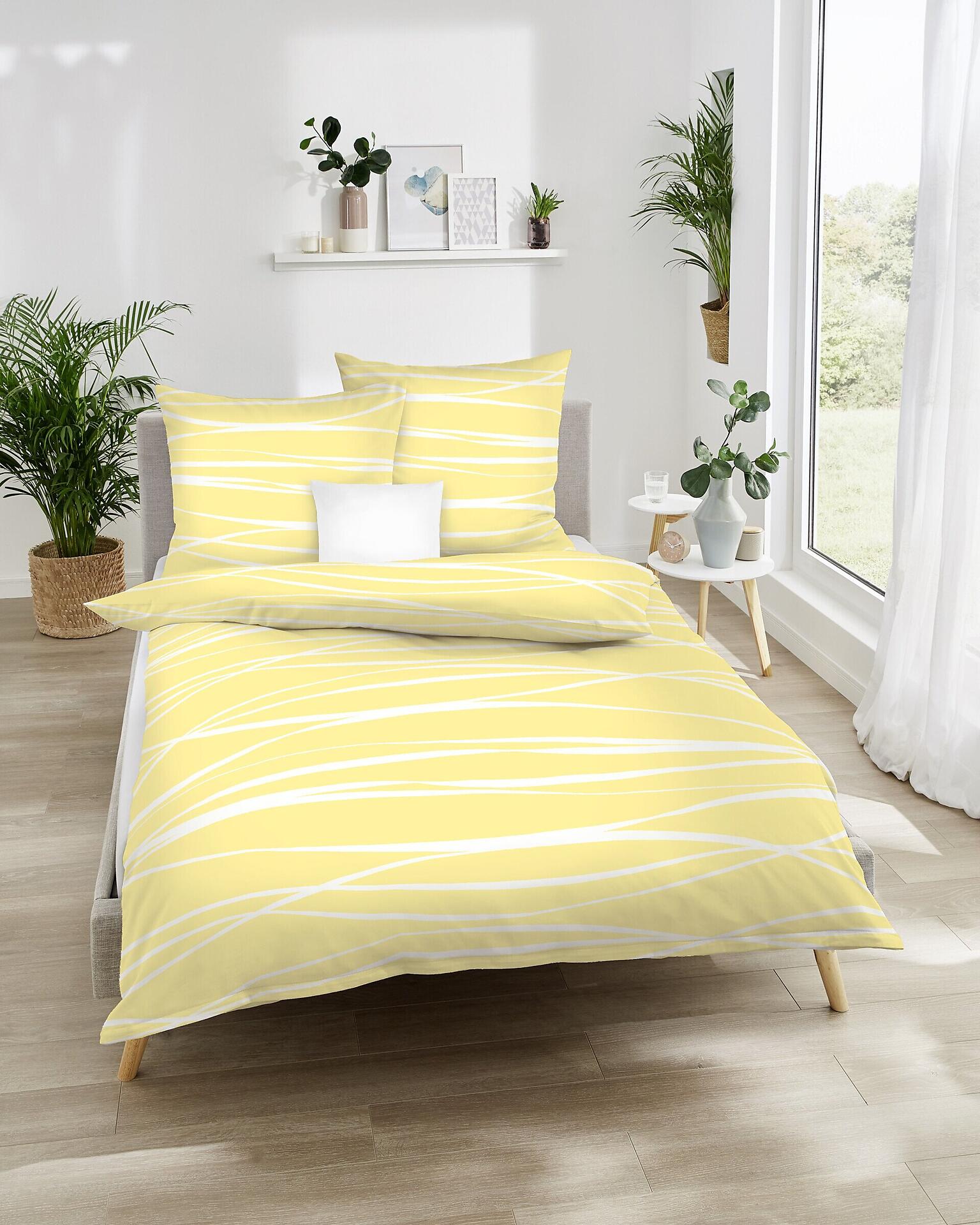 Bettwäsche Motion Colours mit Wellen-Design in Gelb und Weiß, bestehend aus einem Bettbezug und zwei Kissenbezügen, aus Satin und 100% Baumwolle.