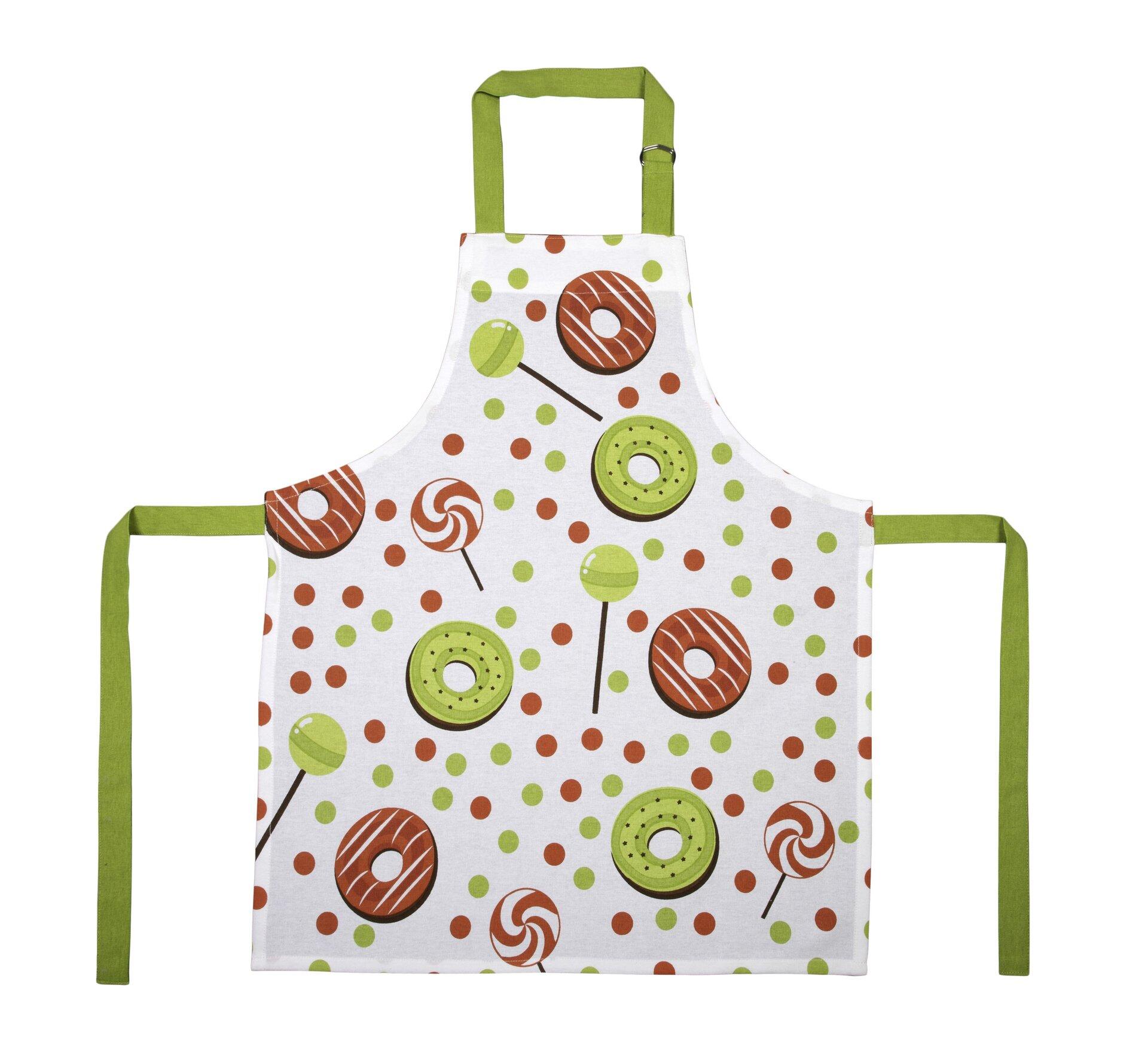 Weiße Kinderschürze mit buntem Donut- und Punkte-Muster und grünen Bändern.