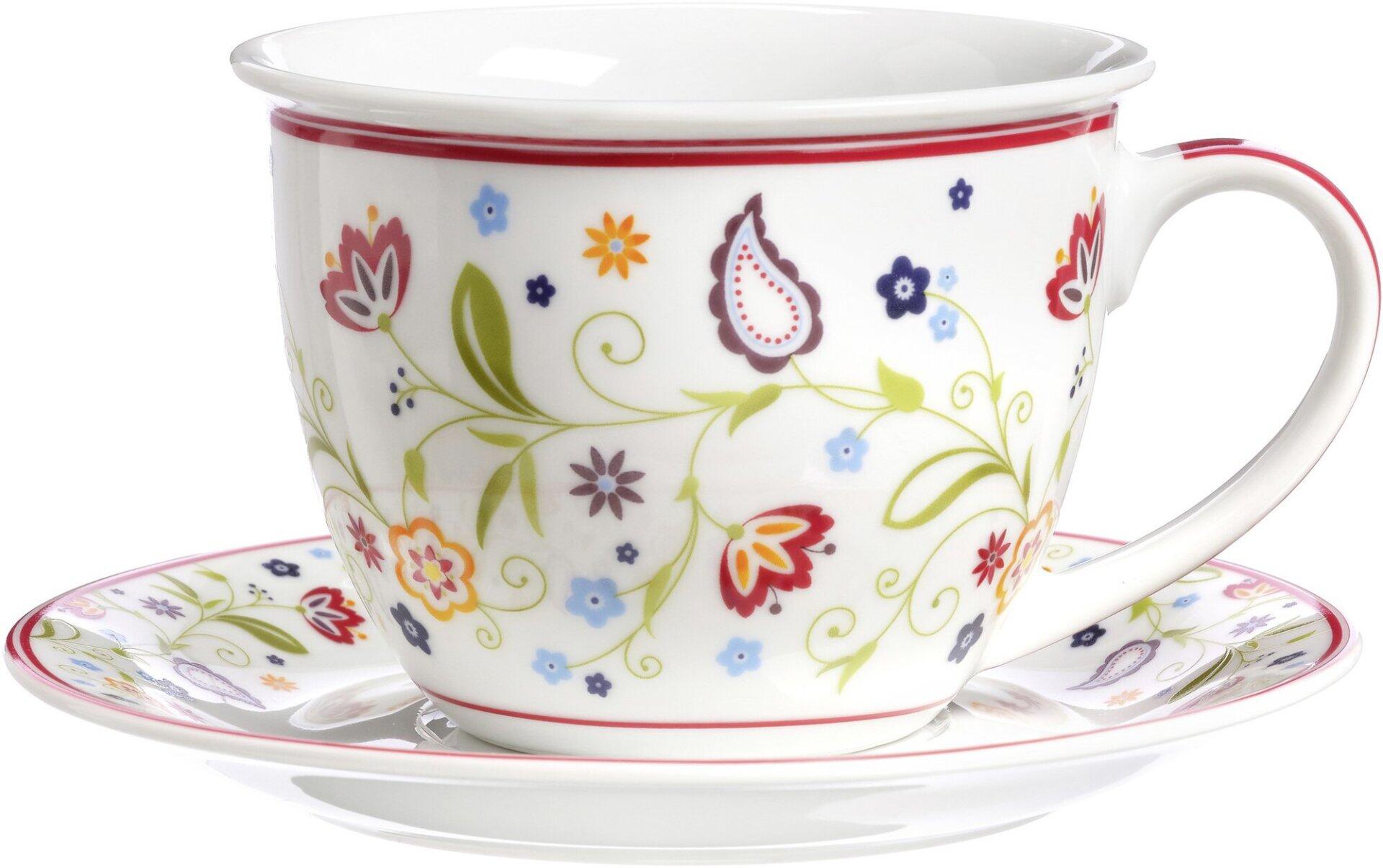 Ritzenhoff & Breker Jumboobere Shanti Tasse mit passender Untertasse auf weißem Grund, verziert mit roten Blüten, grünen Blättern, blauen Sternen und orangefarbenen Blumen.