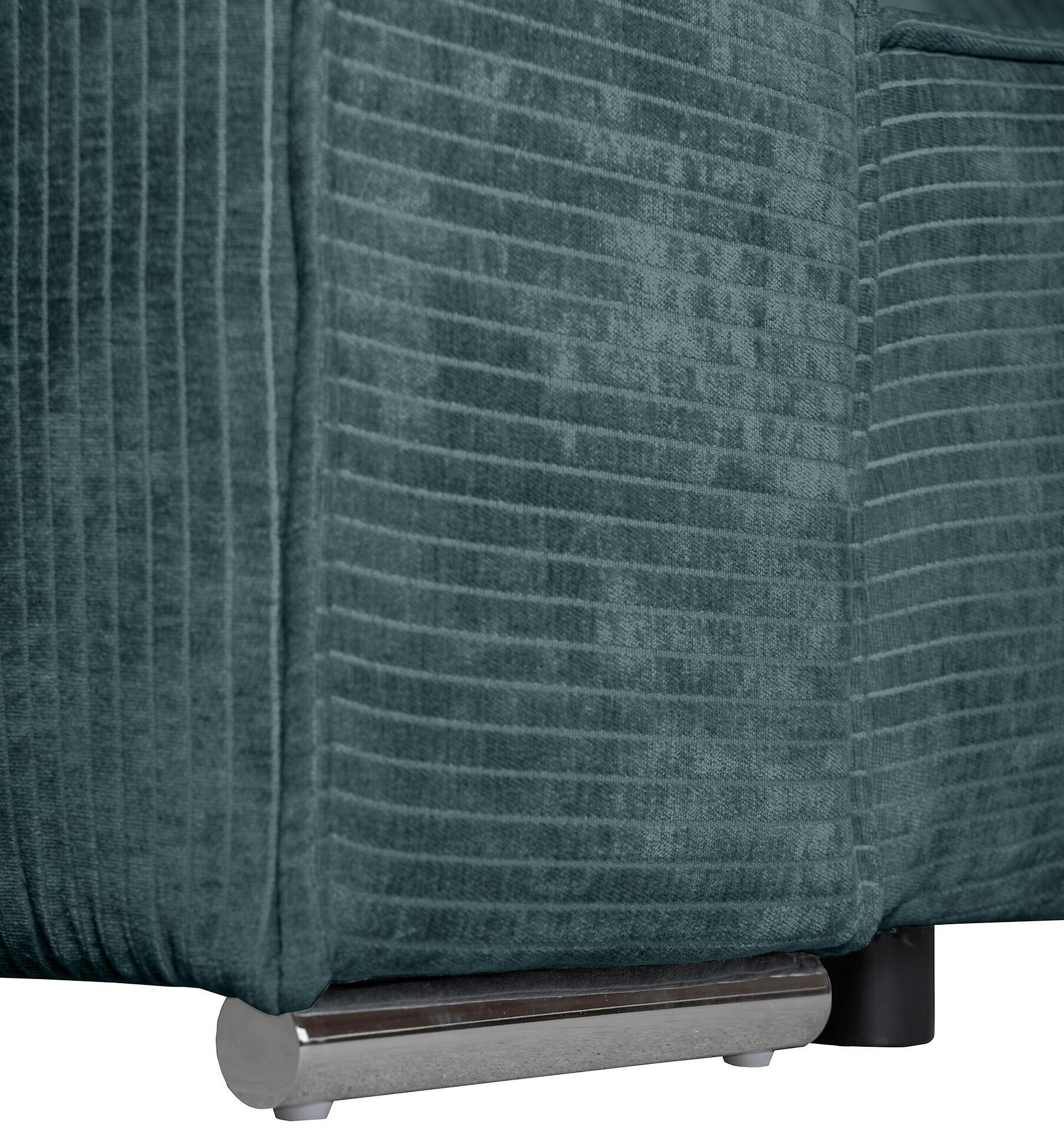 Detailaufnahme des Bigsofa Sky: chromfarbener Metallfuß, der an einer dunkelgrünen, strukturierten Rückenlehne befestigt ist und einen modernen, schwebenden Eindruck vermittelt.