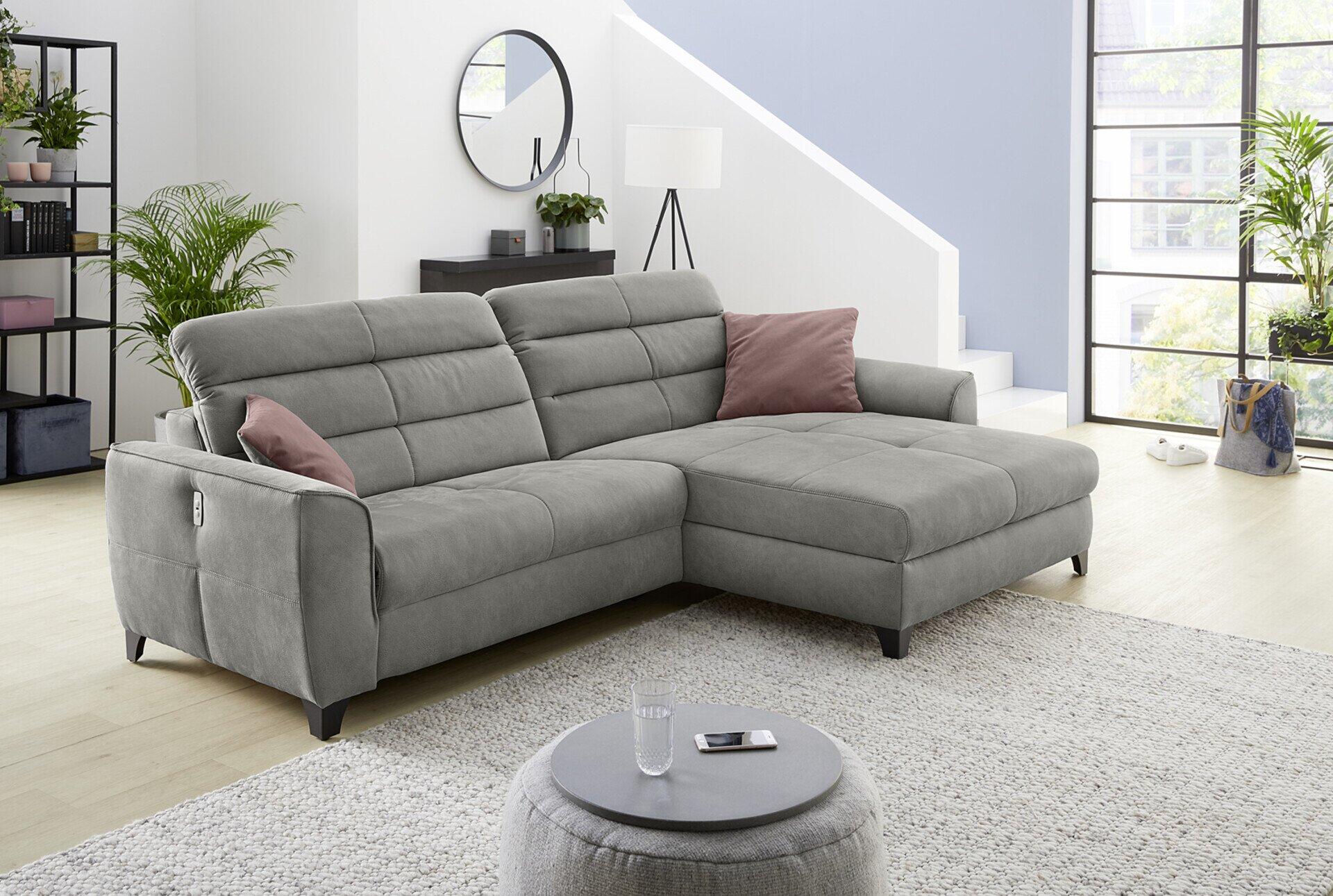 Wohnlandschaft Double One mit Relaxfunktion und verstellbaren Kopfstützen, abgebildet aus erhöhter Perspektive mit gewölbter Sitzfläche und Kissen in Rosaton.