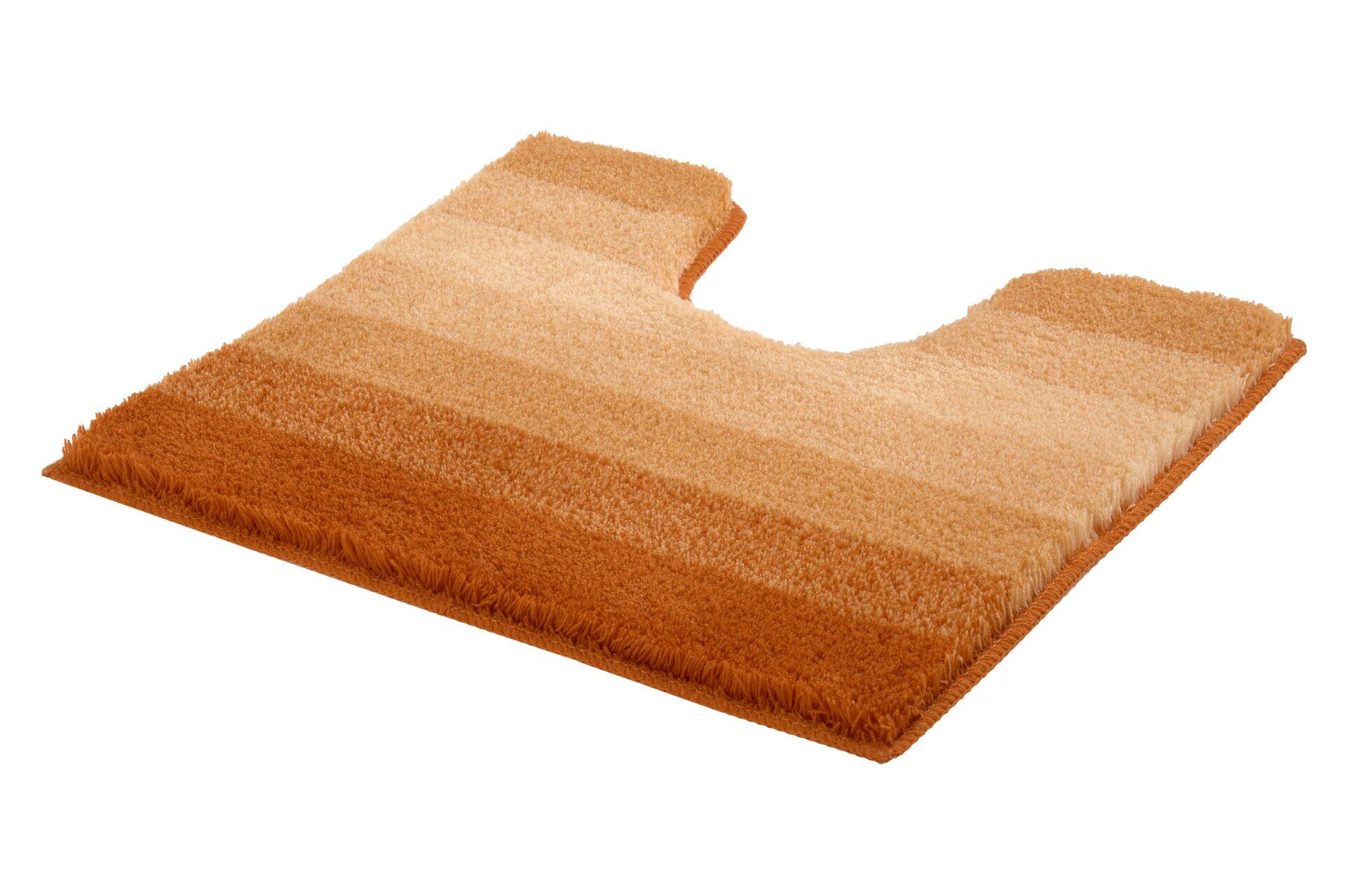 Flauschiger WC-Vorleger Palace mit abgerundeter Form und strukturierter, fellartiger Oberfläche in warmen Orange- und Beige-Tönen.