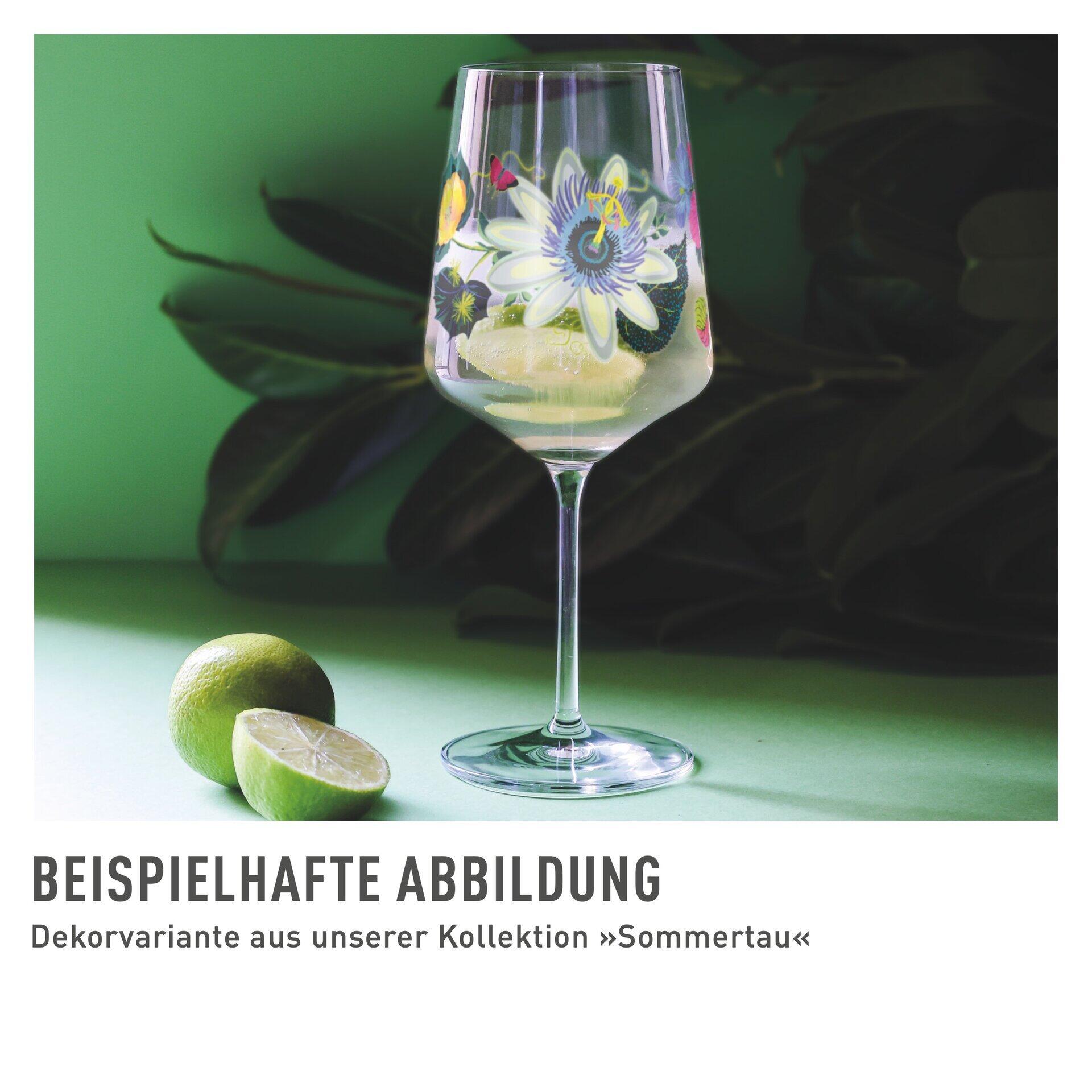 Nahaufnahme eines Tucan Aperitifglases mit floralem Muster vor tropischem Hintergrund, das die elegante Kelchform und den schlanken Stiel betont.
