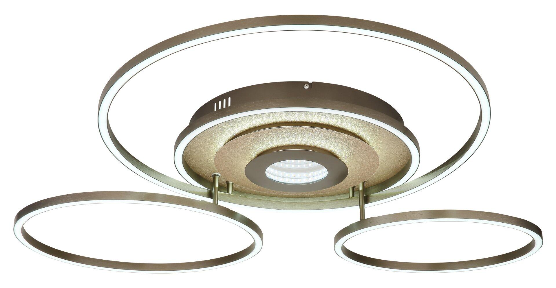 Moderne Deckenleuchte MILES mit drei ringförmigen LED-Leuchtflächen und zentralem Kern, dargestellt im Gegenlicht mit strukturierter Basis und Bedieneinheit.