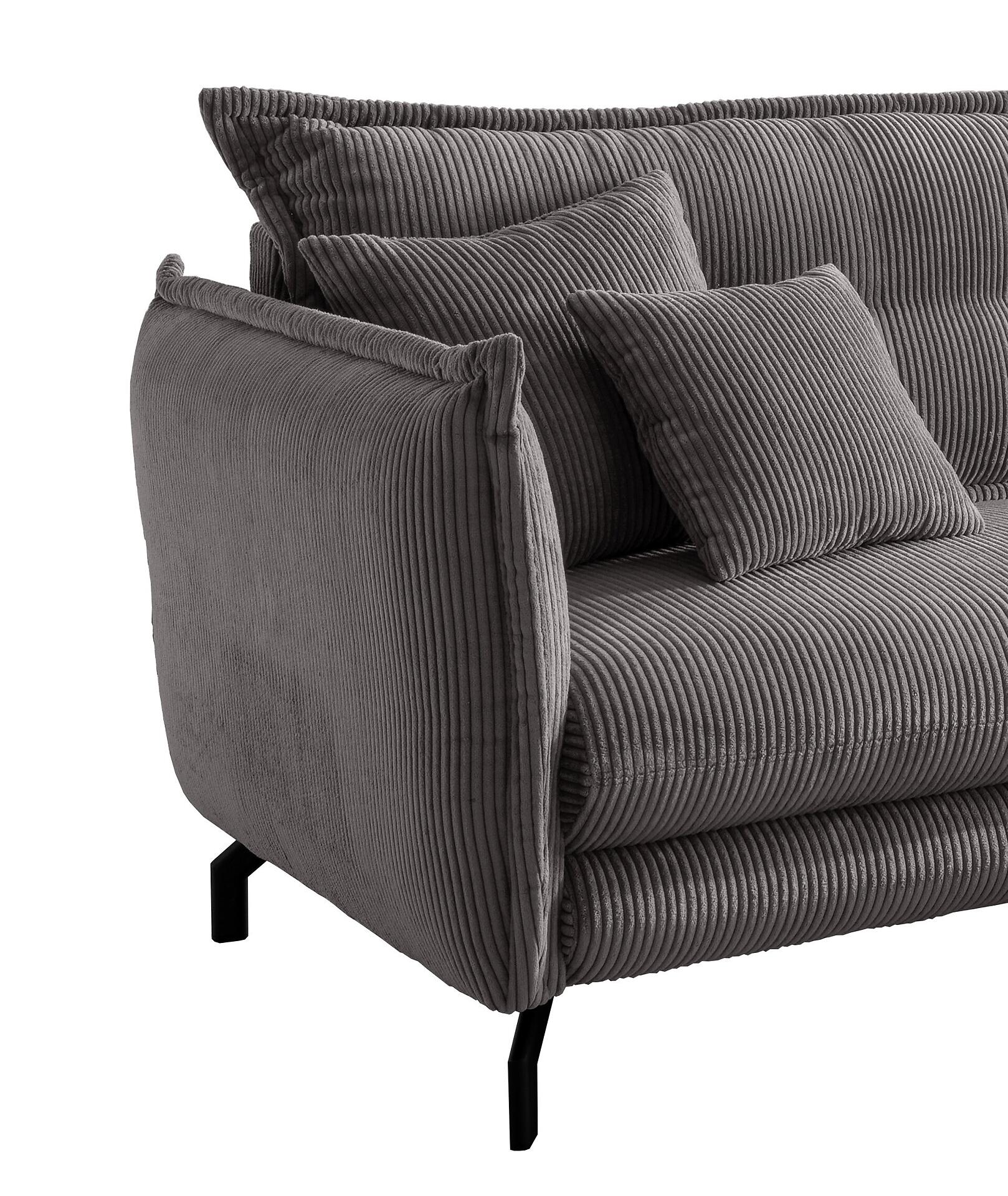 Detailaufnahme des Ecksofas Lava: Schräge Ansicht des linken Sofarückens und -arms zeigt die breite, weiche Rückenlehne, die leicht gewölbten Armlehnen und die metallischen, schwarzen Winkelfüße.