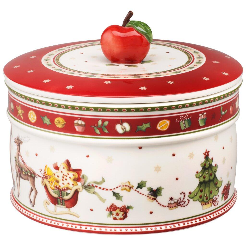 Weihnachtliche Gebäckdose "Winter Bakery" von Villeroy & Boch mit rotem Deckel, verziert mit Schlitten, Weihnachtsmann, Sternen und einem Apfel als Knauf, aus der Vogelperspektive.