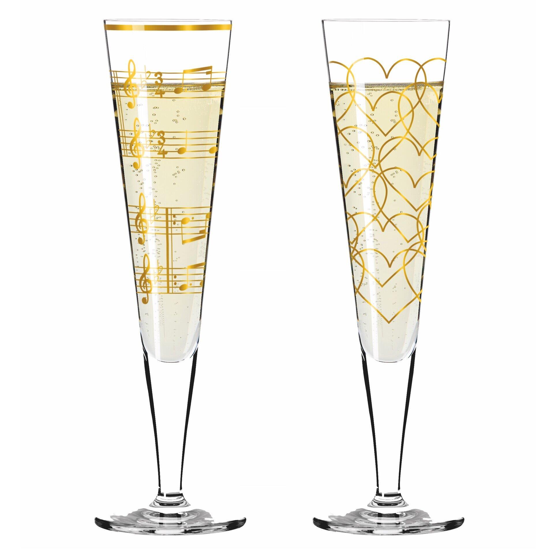 Zwei Champagnergläser mit goldenem Notenschrift- und floralem Dekor, präsentiert in einem Frontalwinkel und verpackt in einer Geschenkbox.