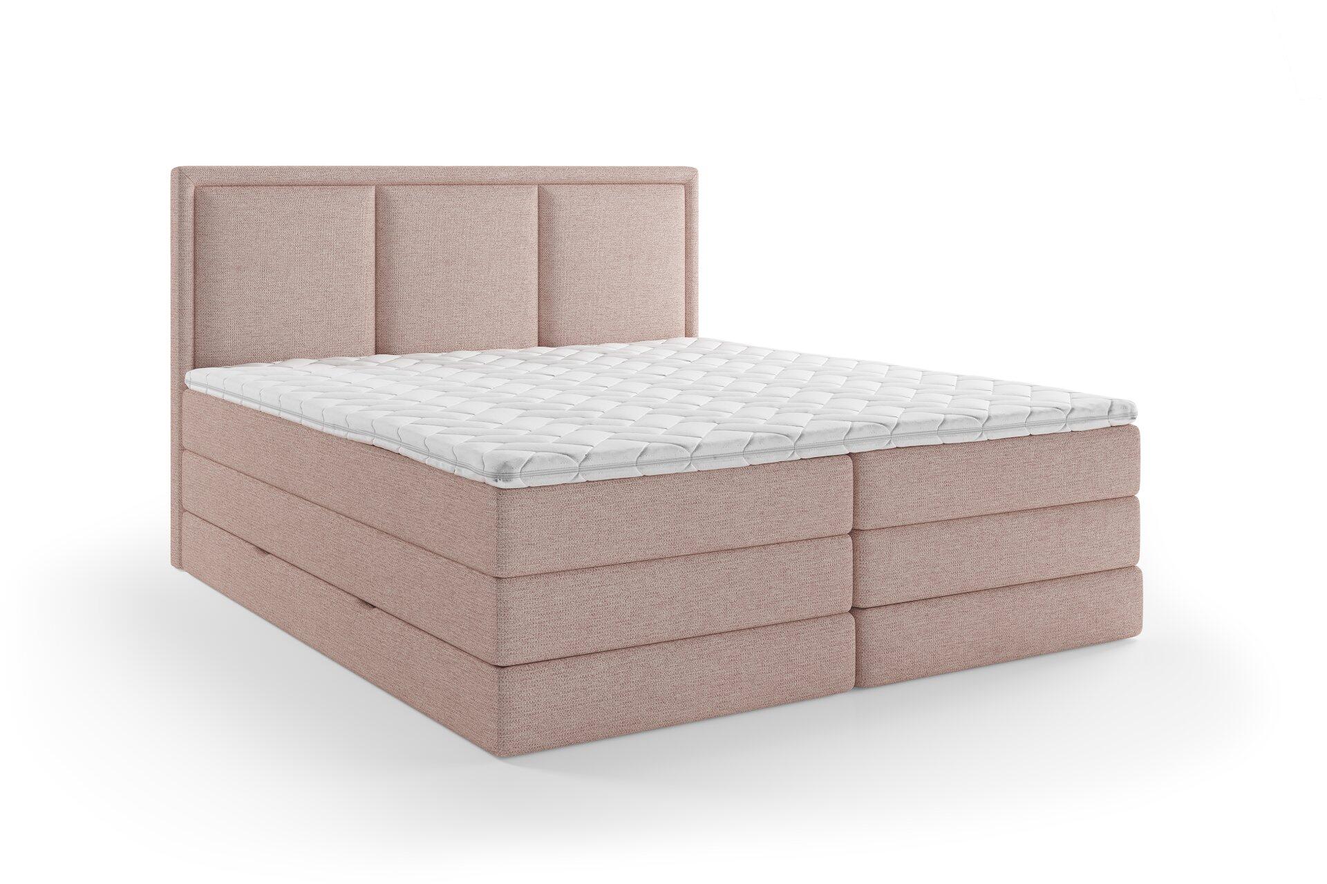 Helles Boxspringbett "Swing" mit gestepptem, hochgewölbten Kopfteil und Box, seitlich und leicht von oben aufgenommen.