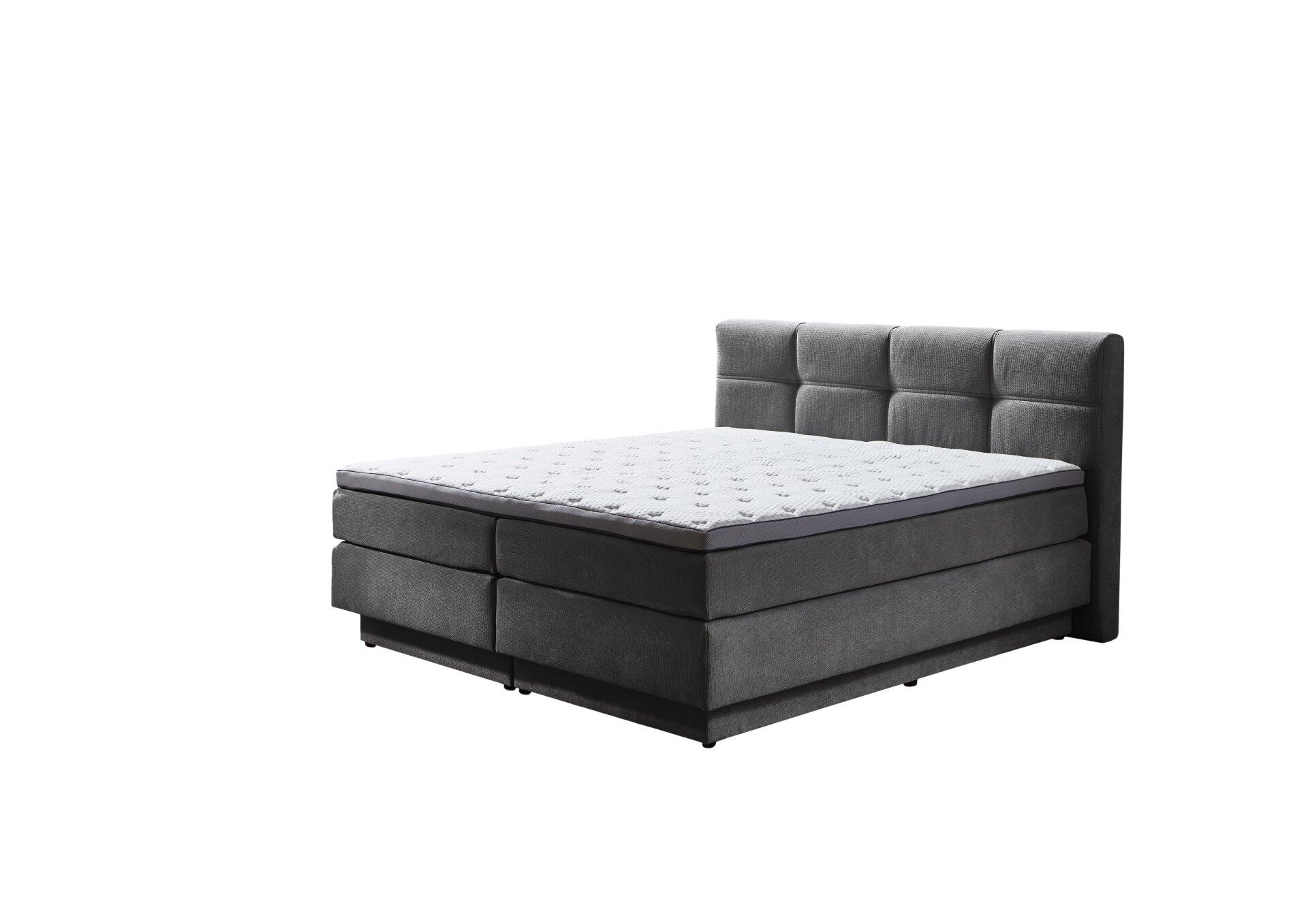 Boxspringbett Portage BX2110 mit grauem Stoffbezug, Karomuster am Kopfteil und integrierten Schubladen zur Aufbewahrung, aus der Vogelperspektive dargestellt.