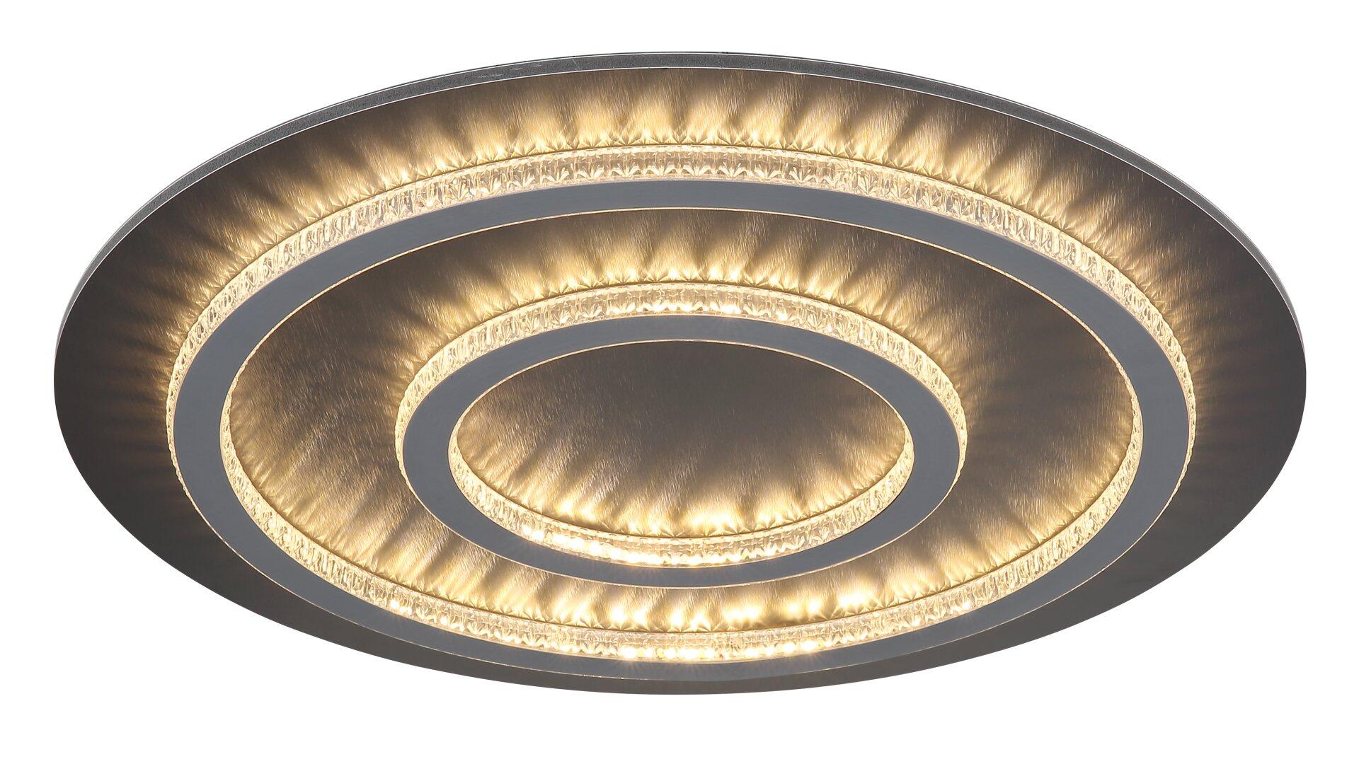 Deckenleuchte JAYDEN mit flachem Design und versetzten, silbernen Ringen, die durch warmes, goldenes Licht betont werden.