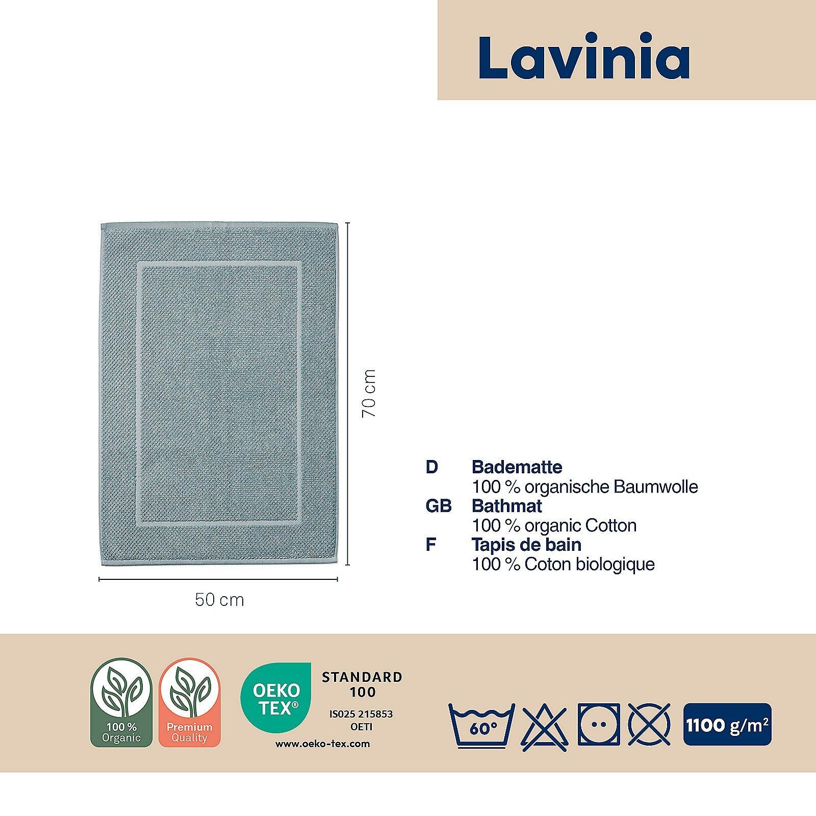 Dunkelblauer Badvorleger Lavinia aus Bio-Baumwolle mit den Maßen 50x70 cm, der auf einem hellen Untergrund liegt und Zertifizierungen für Bio-Qualität und Öko-Tex Standard 100 trägt.